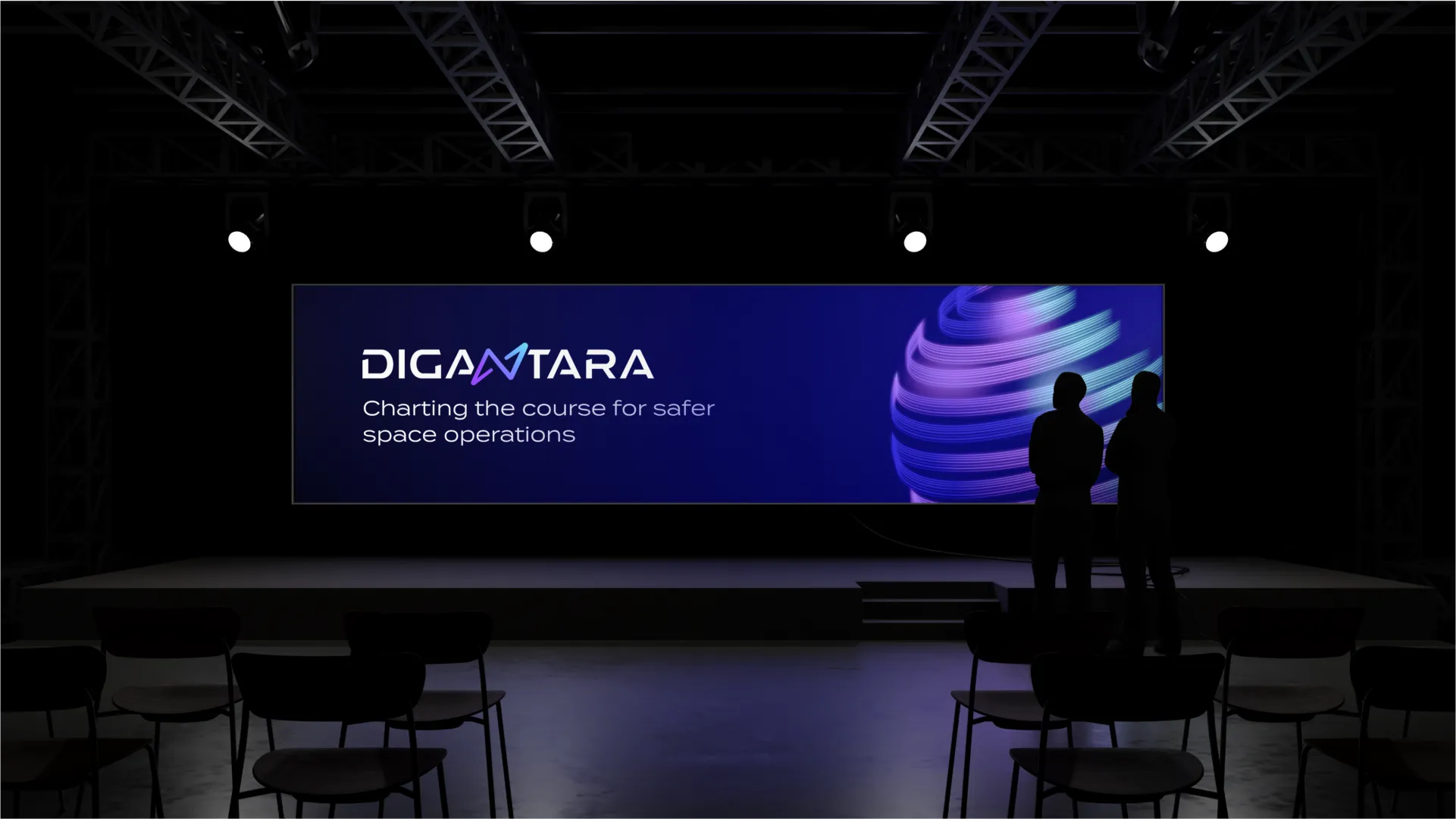 Two men watching an event stage featuring Digantara branding in a theatre setup.