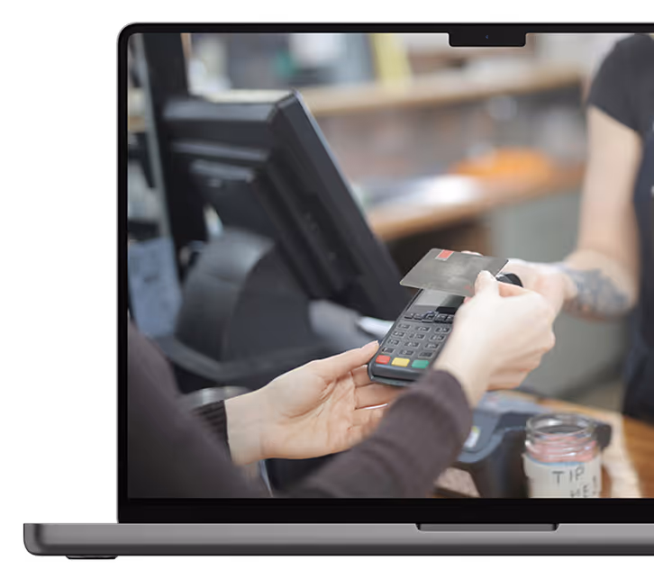 Image of laptop and person tapping card on Funding Alliance website