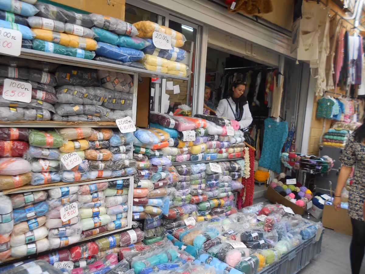 The outside of a European shop selling many spools of yarn