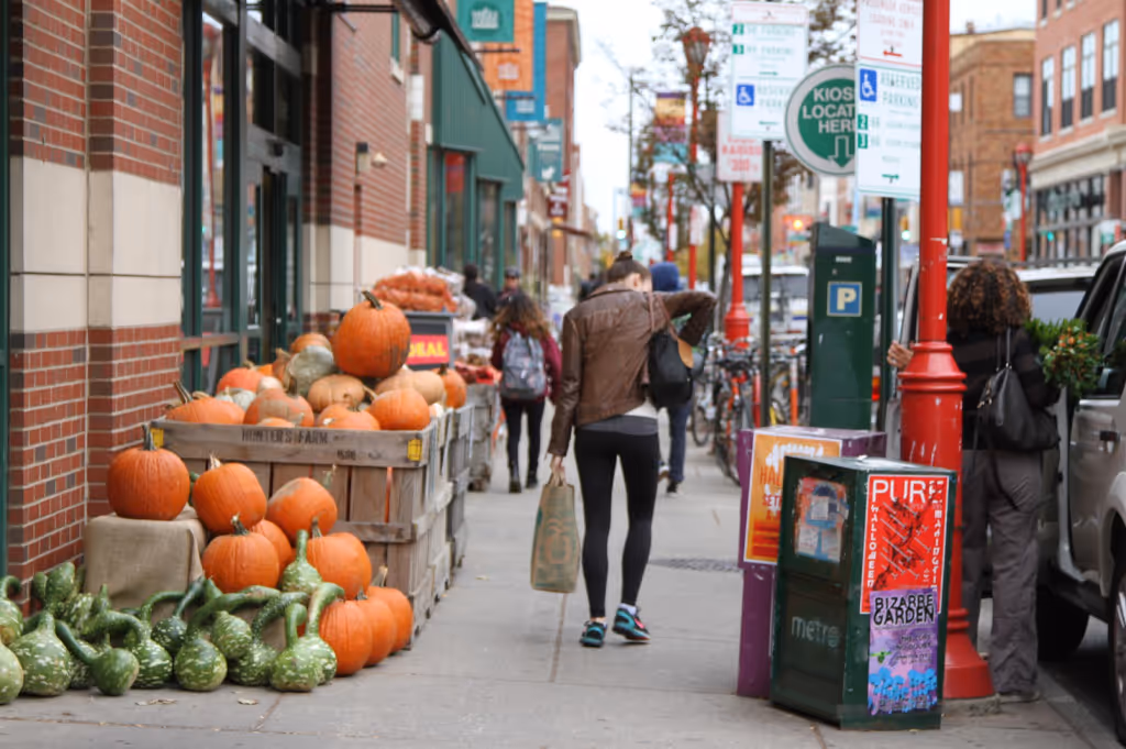 Person walking down sidewalk next to produce