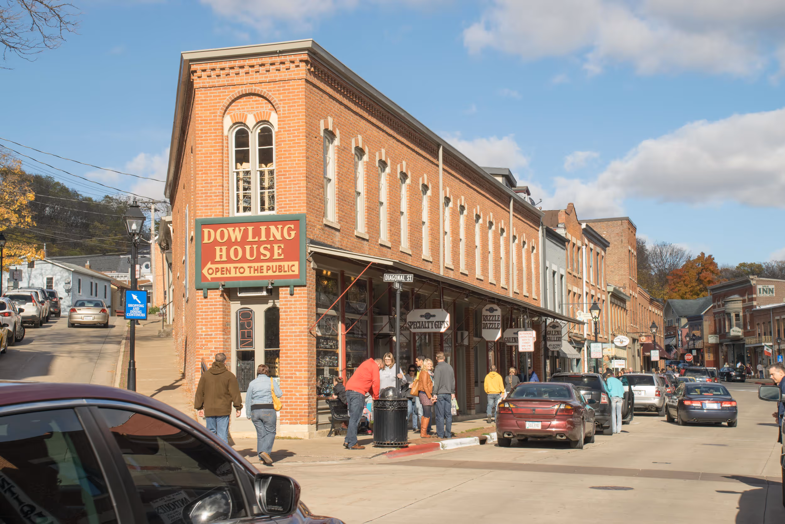 Traditional brick store on a street with a sidewalk filled with people