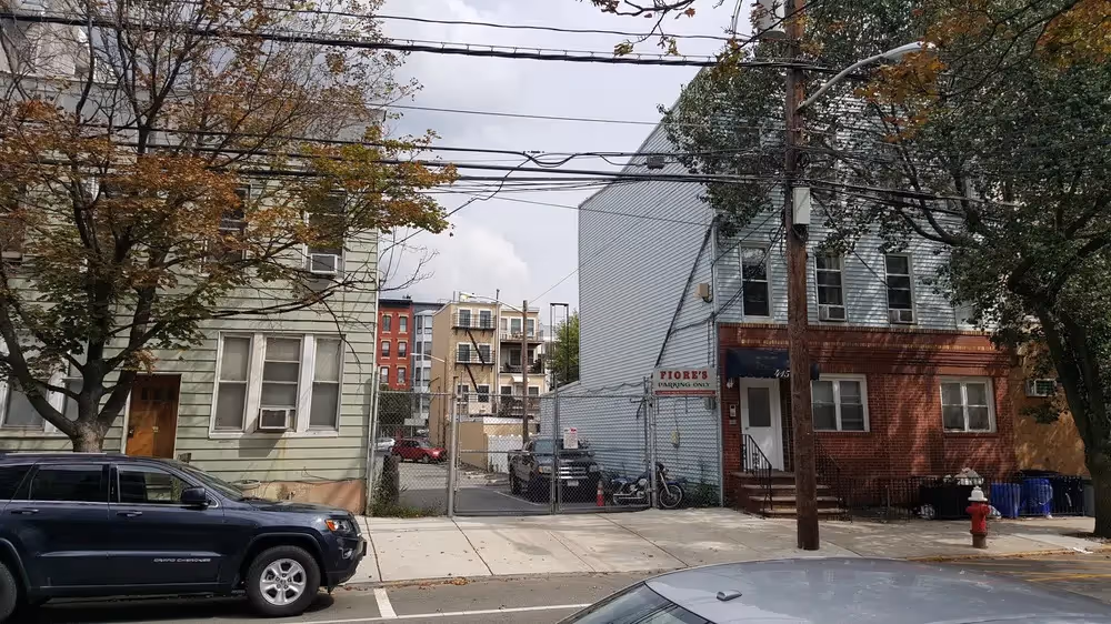 Two small buildings bordering an empty lot