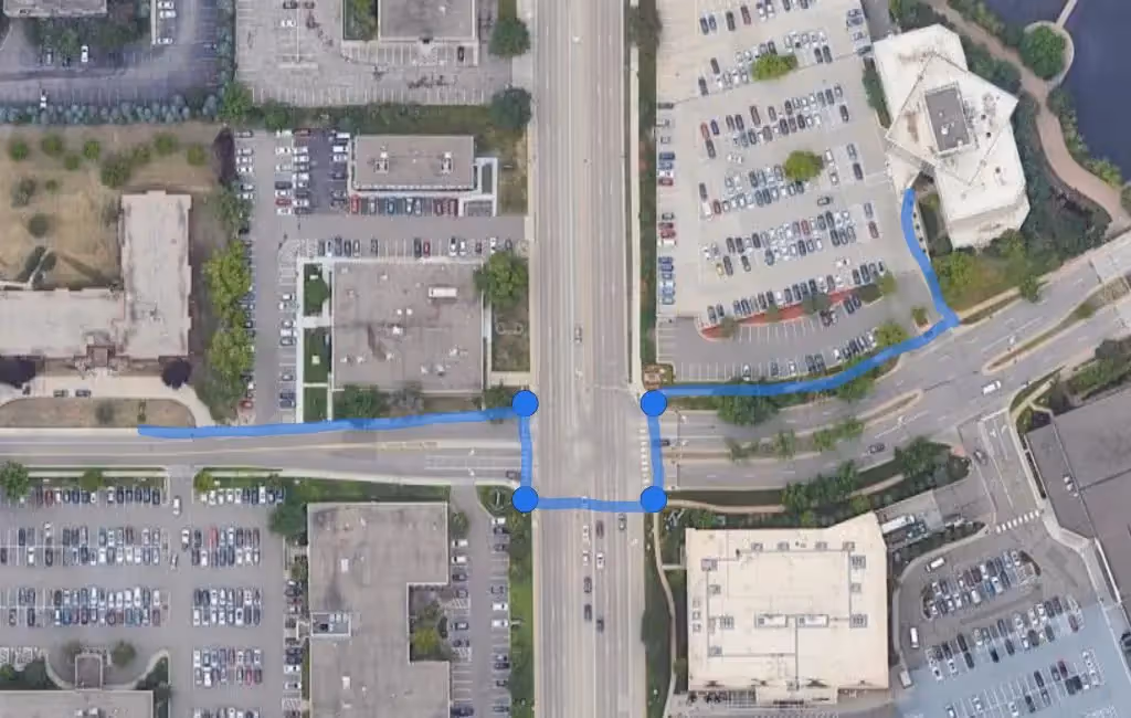 Aerial photo of street with unsafe pedestrian path of travel drawn overtop