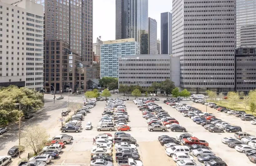 Big parking lot in Dallas surrounded by high rise buildings
