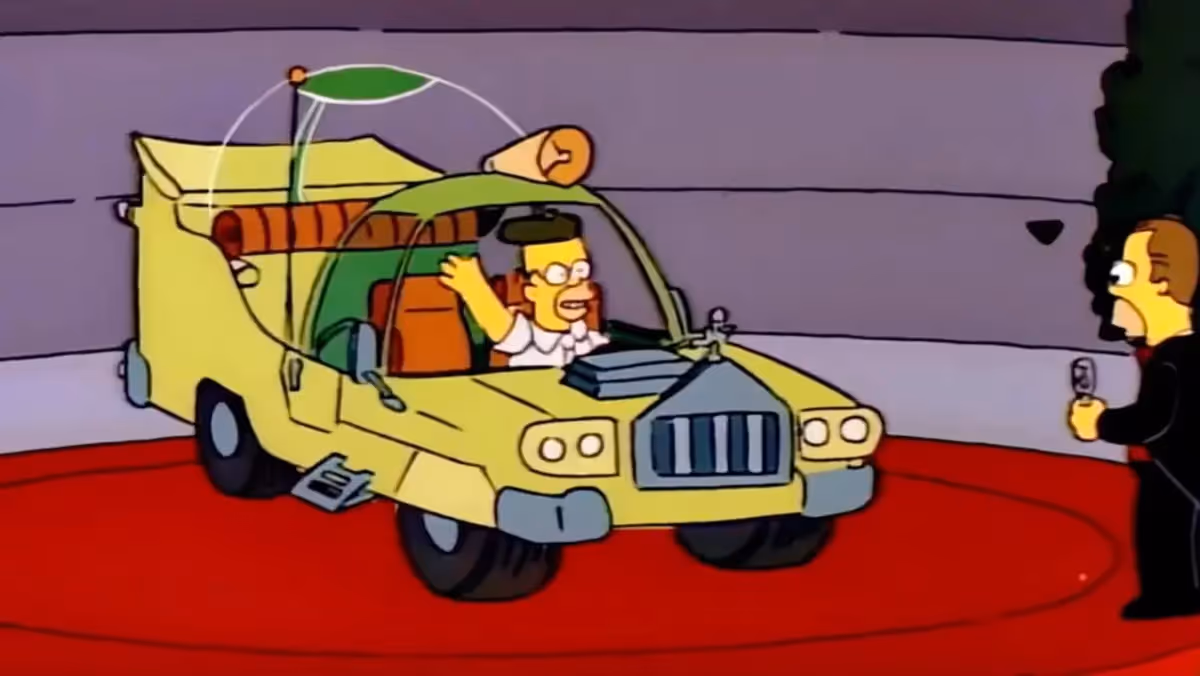 Simpsons graphic of man in car on stage