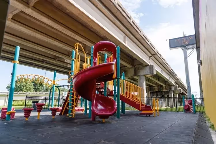 Playground in shadow under highway