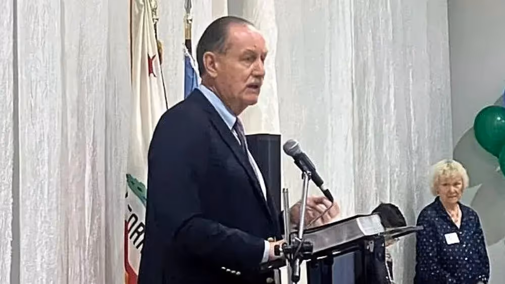 Rick Cole speaking at a podium