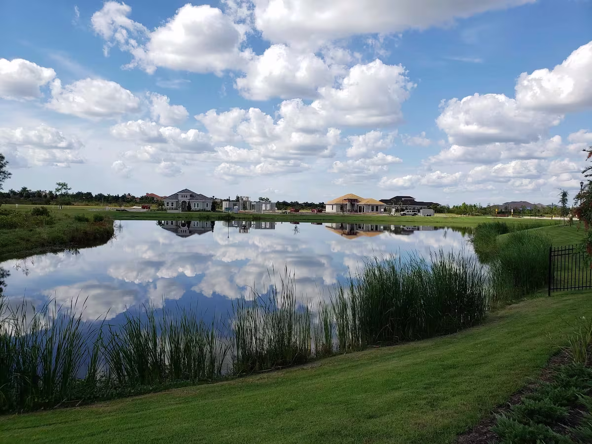 Two residential houses across from a lake