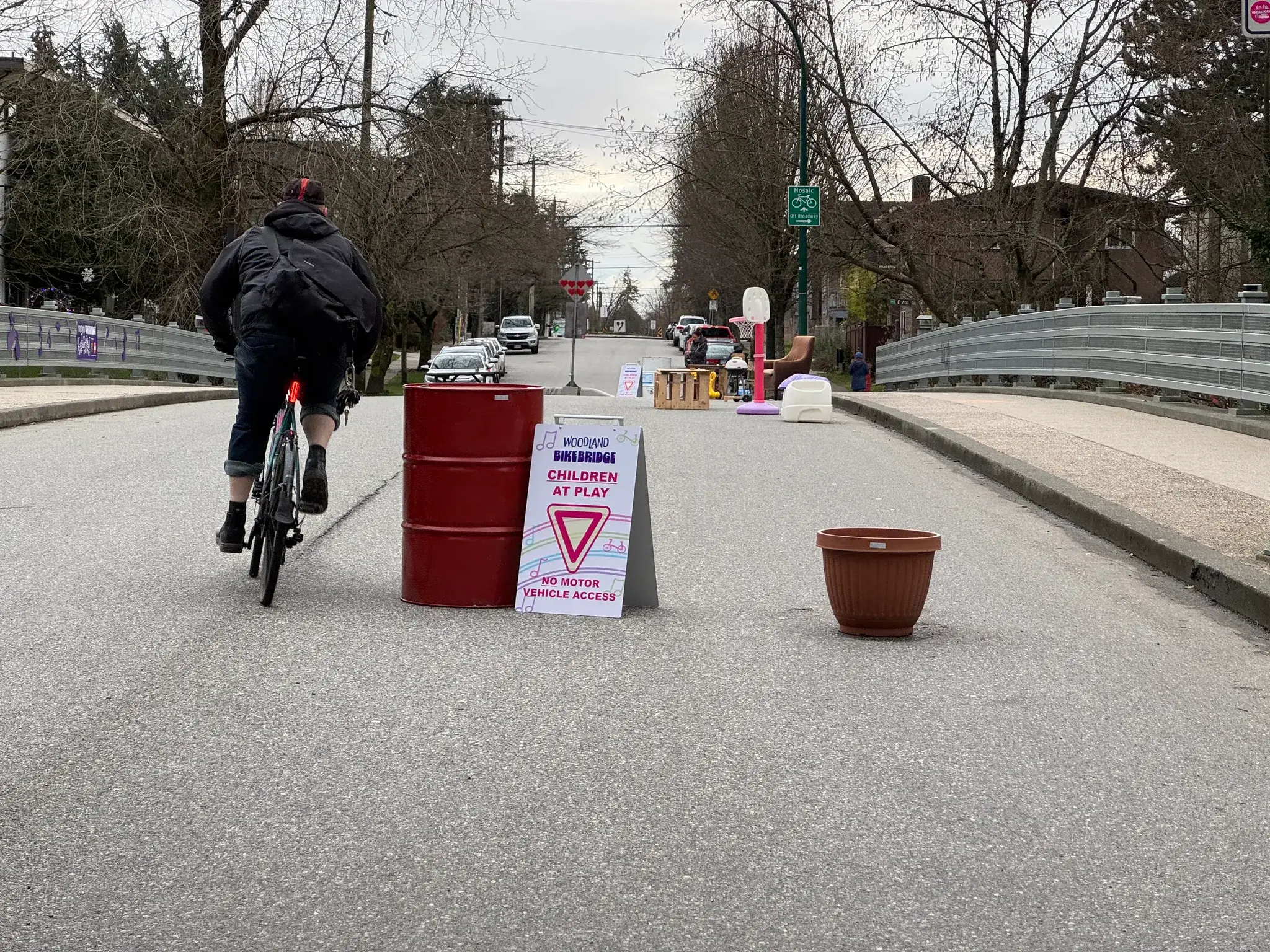 A person is riding a bike through Woodland Bike Bridge