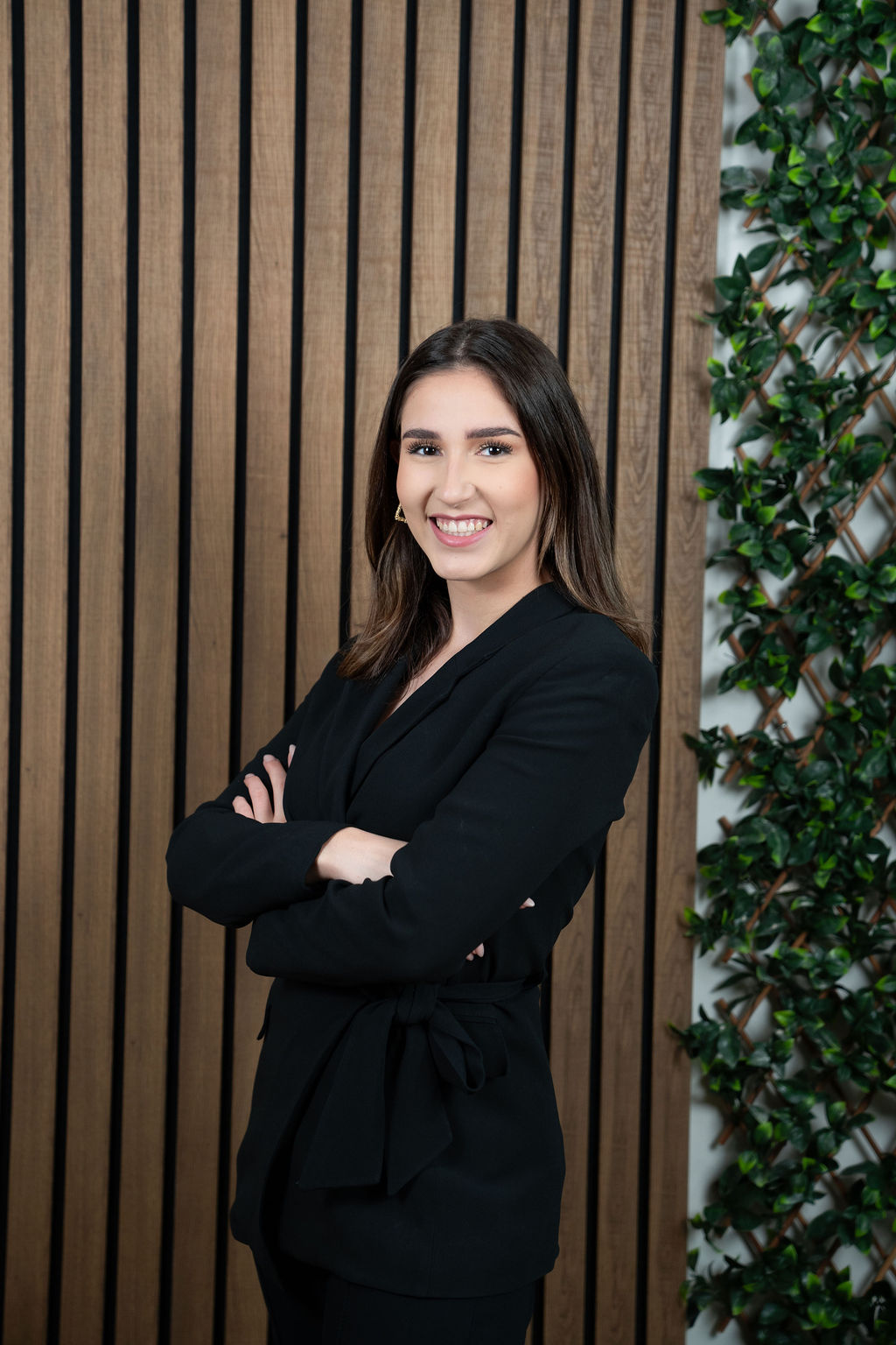 Joline Meens standing against wood background