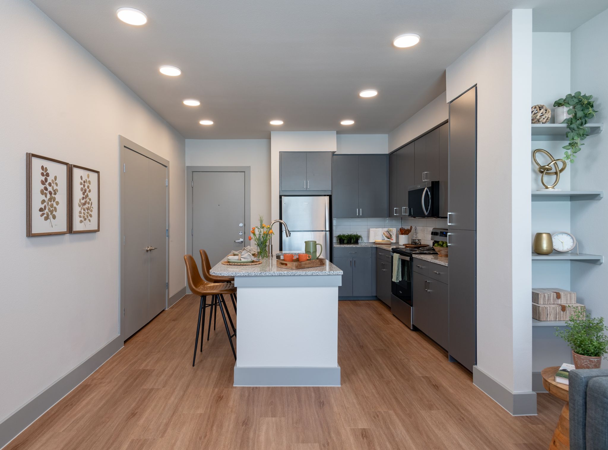 Kitchen with breakfast bar island featuring chairs and stainless steel appliances