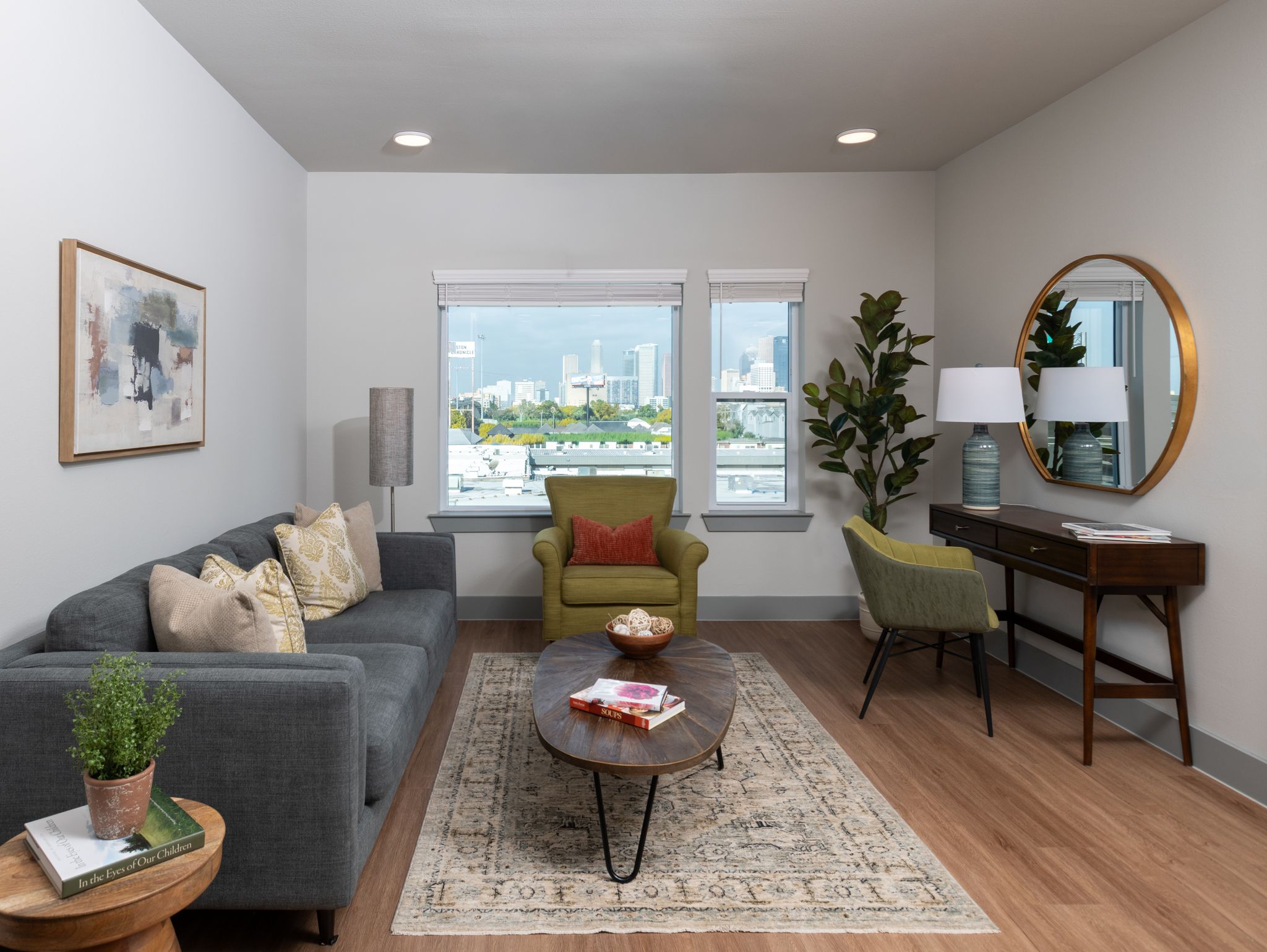Living room with sofa, coffee table, wall art, and large window