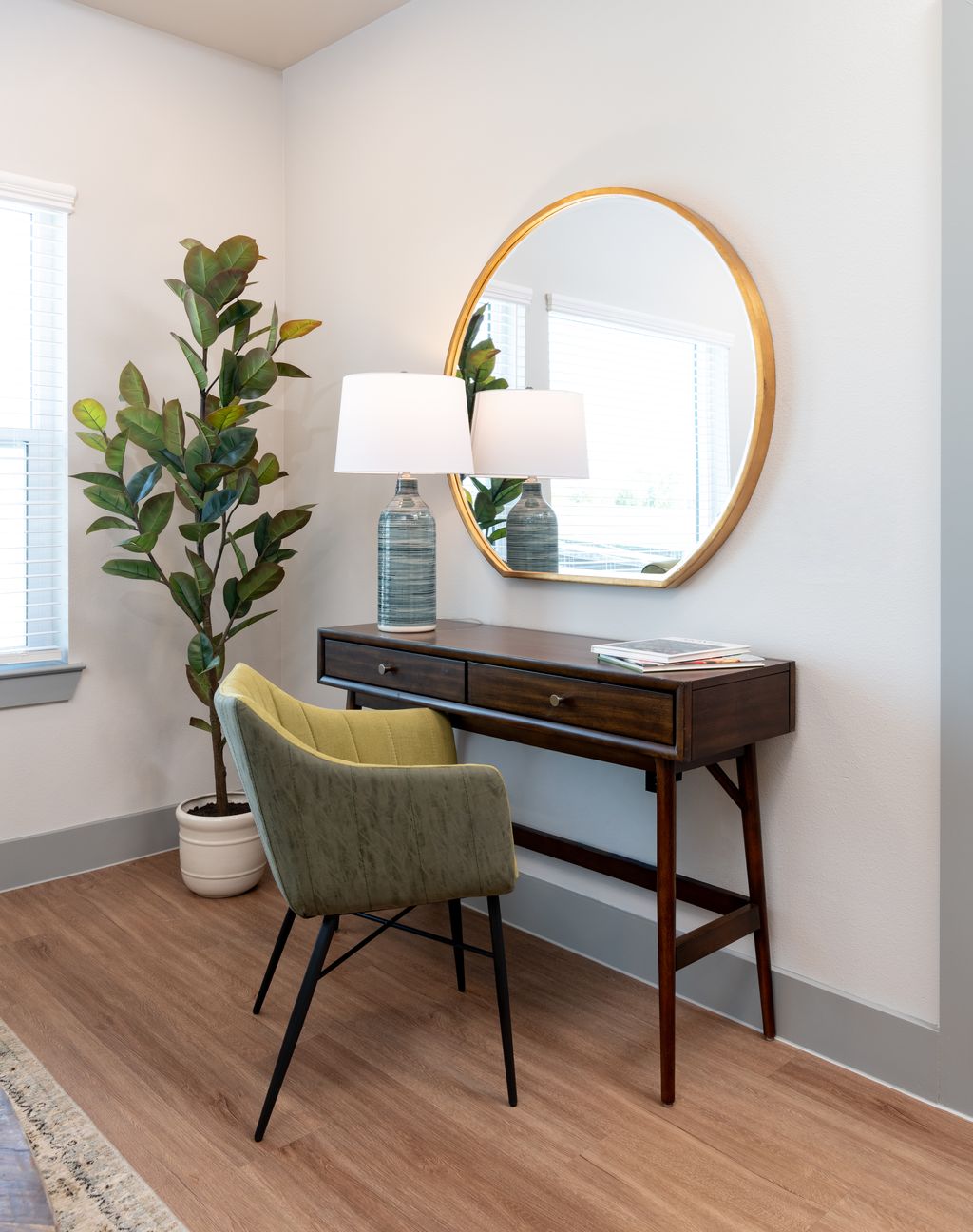 Desk area with desk, plant, and mirror decor