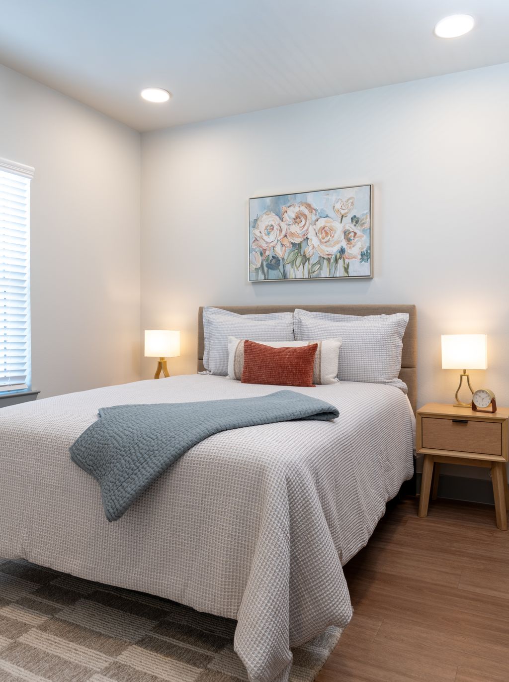 Bedroom with bed, bedside table, and modern wall art