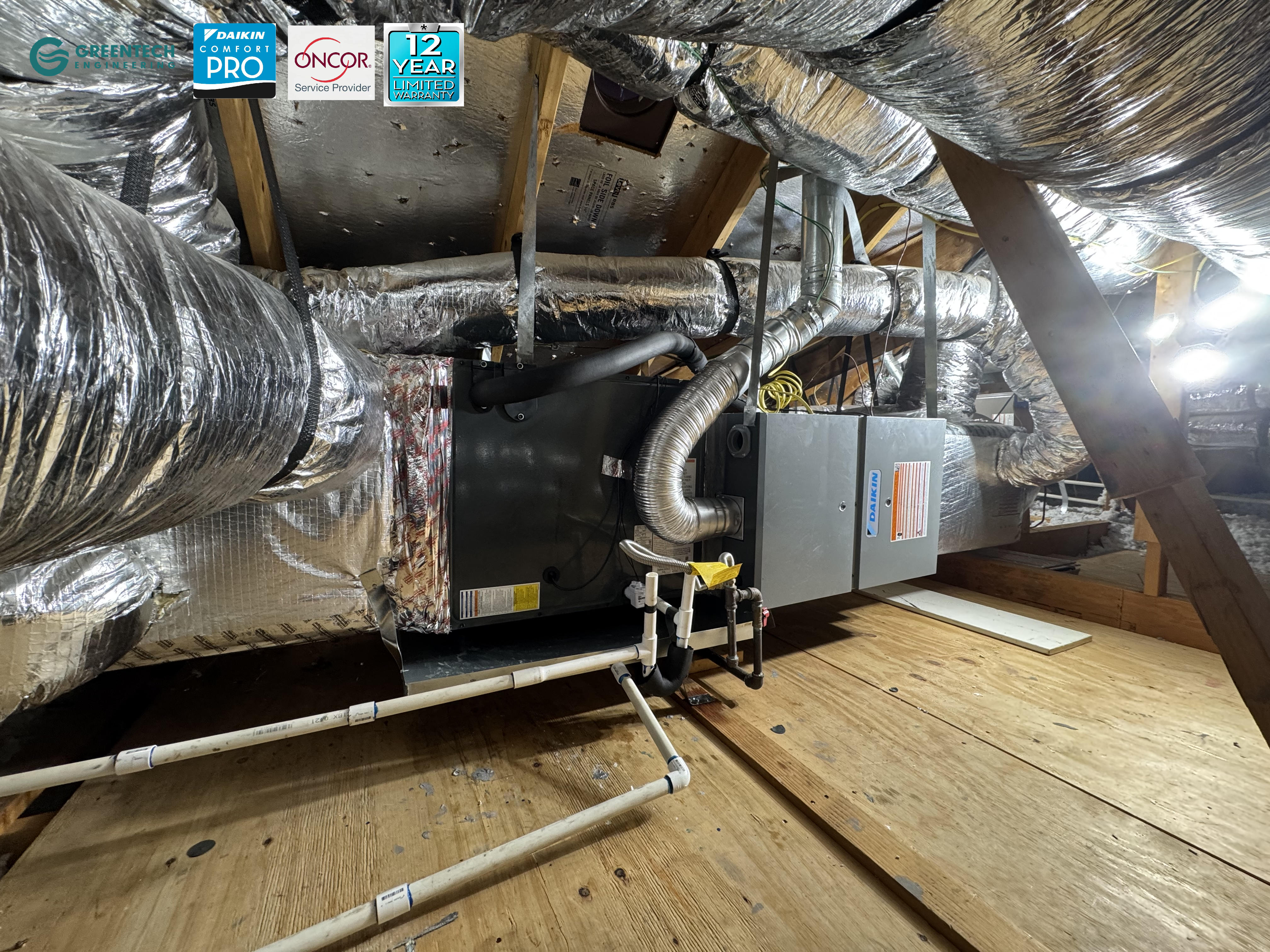 Newly installed Daikin horizontal gas furnace and evaporator coil in a residential attic, sealed with silver HVAC tape.