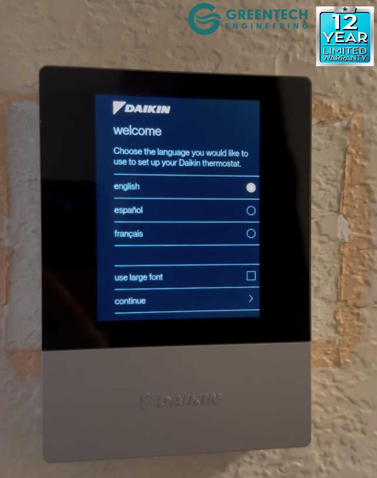 A close-up of the Daikin One Touch Smart Thermostat screen during the initial language setup phase, mounted on a Dallas wall.