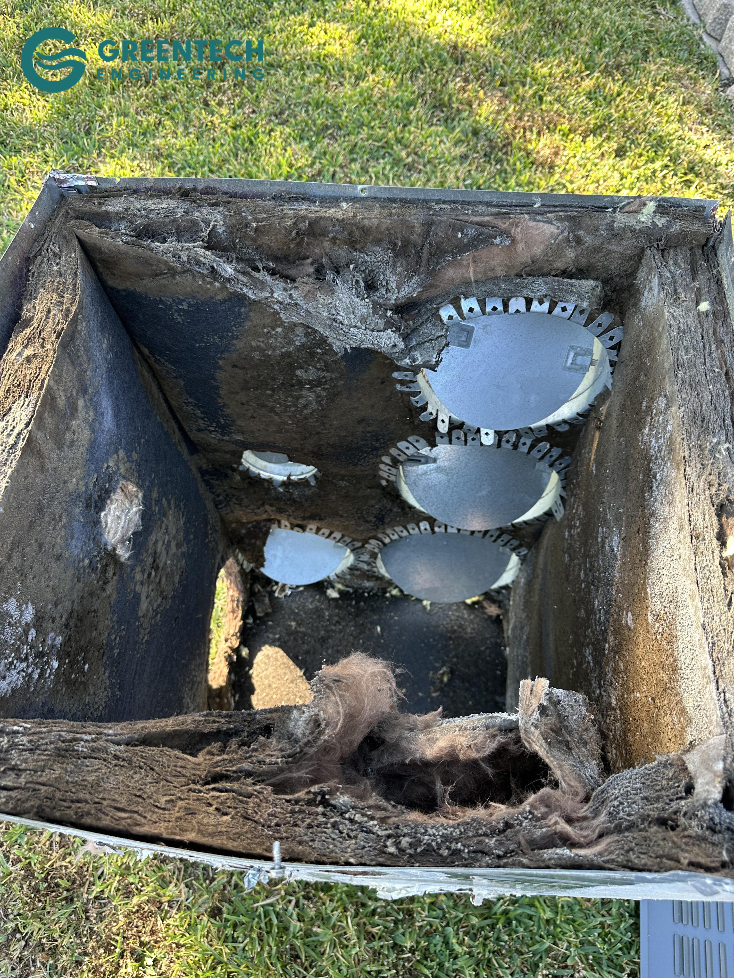 An old, deteriorating, and moldy HVAC supply plenum removed from a Dallas, TX home, showing collapsed insulation and restrictive airflow paths