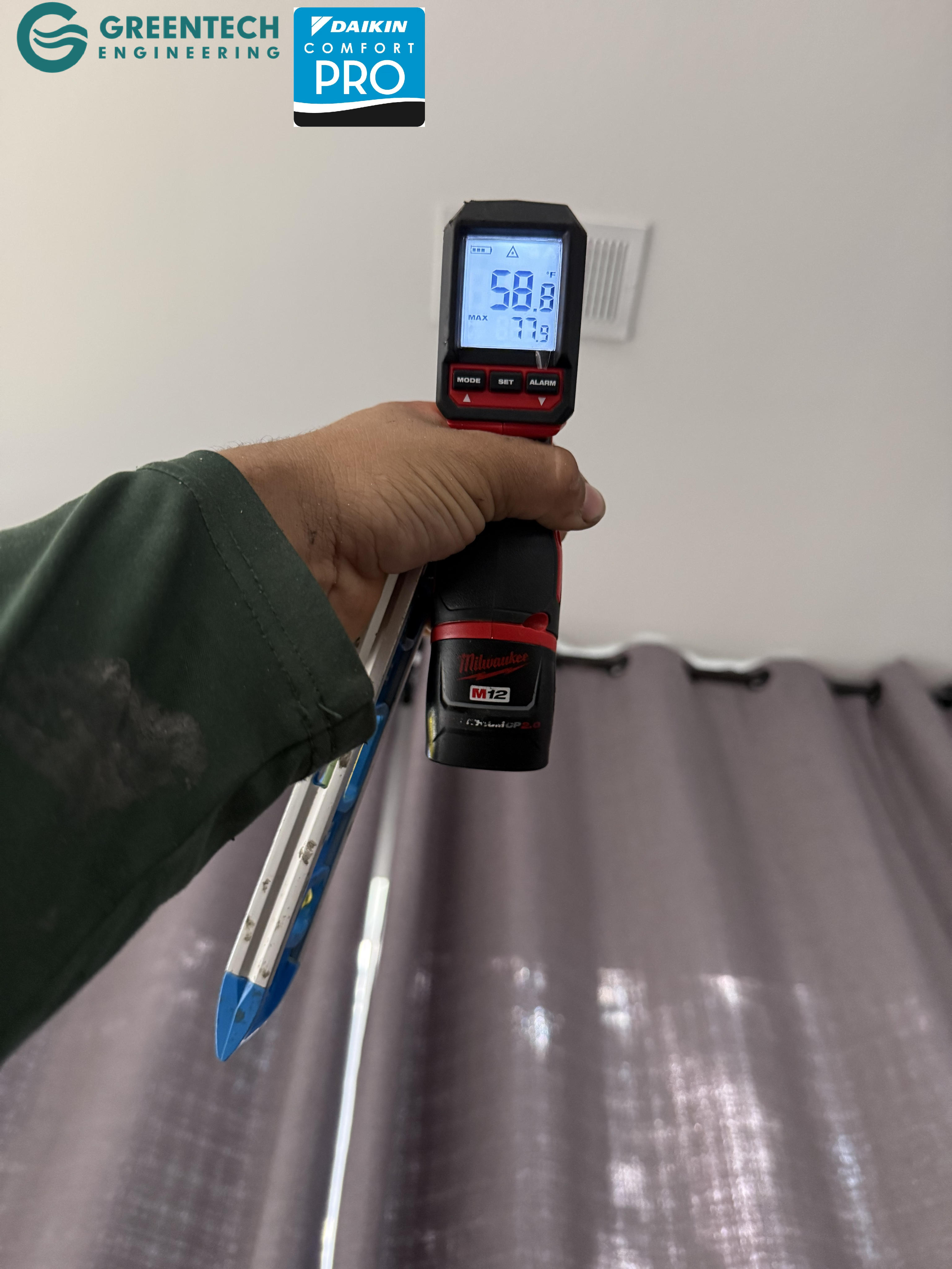 A digital infrared thermometer pointing at a residential ceiling vent in Dallas, registering a freezing 58.8 degrees Fahrenheit.