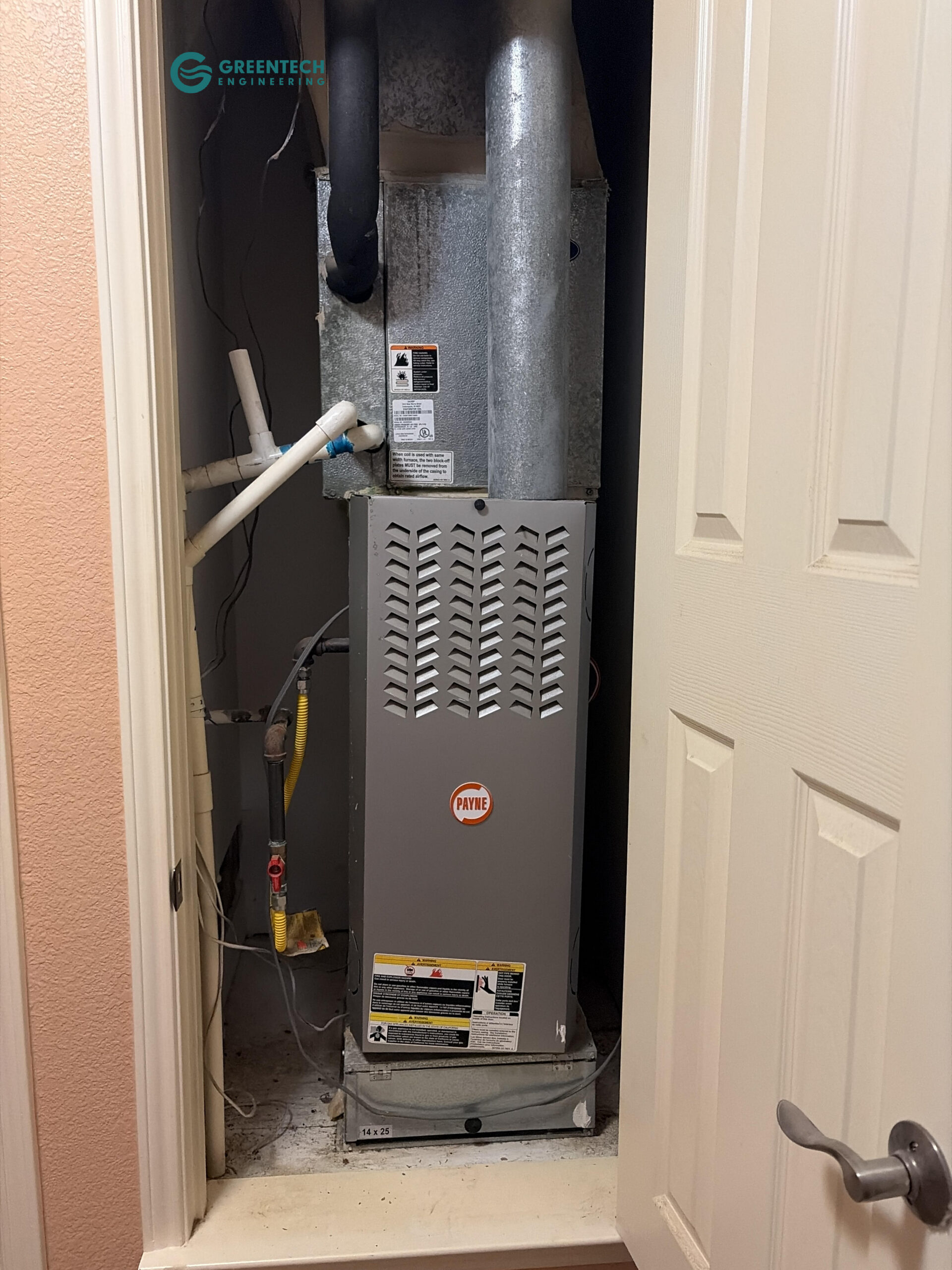 An old, inefficient Payne gas furnace and evaporator coil crammed into a tight second-floor utility closet in a Dallas 75248 home.
