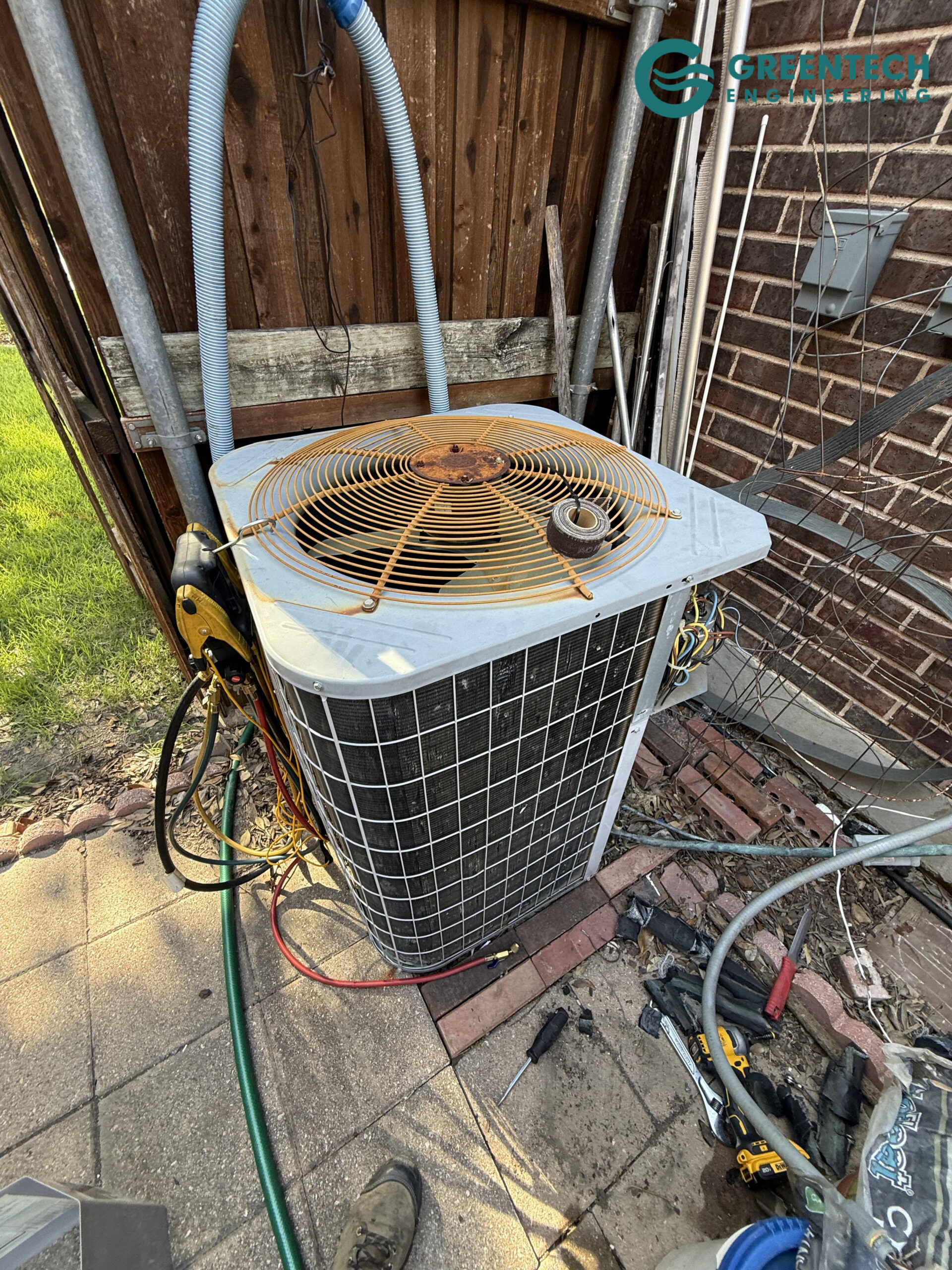 An aging, rusted air conditioning condenser struggling to cool an Allen, TX home before being replaced.