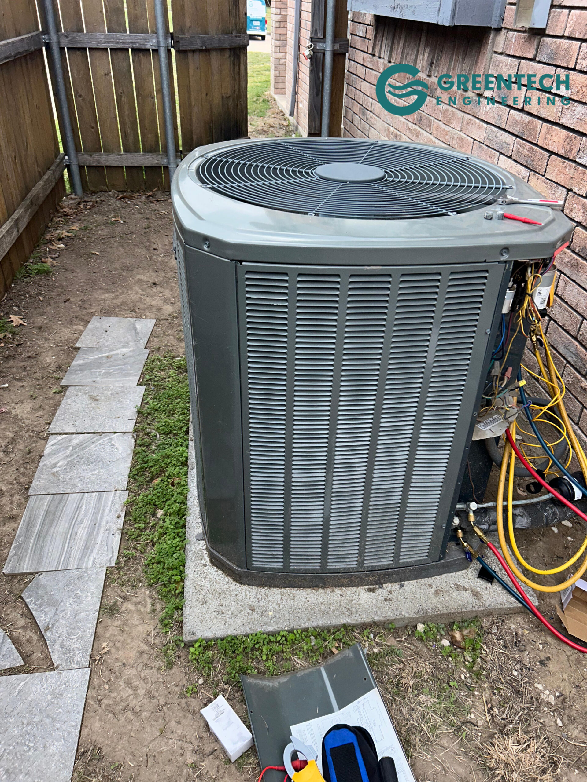 Professional HVAC technician performing a standing pressure test and refrigerant leak search on an outdoor AC condenser in Little Elm