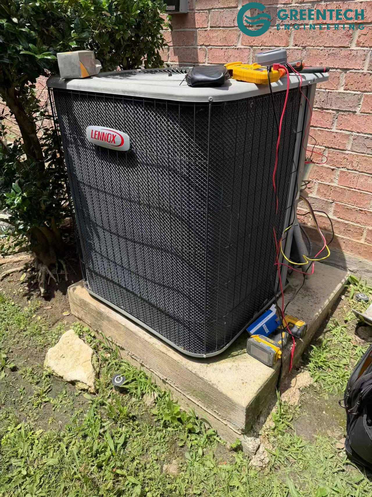 An aging, inefficient Lennox air conditioning condenser sitting outside a brick single-family home in Little Elm, Texas 75068.