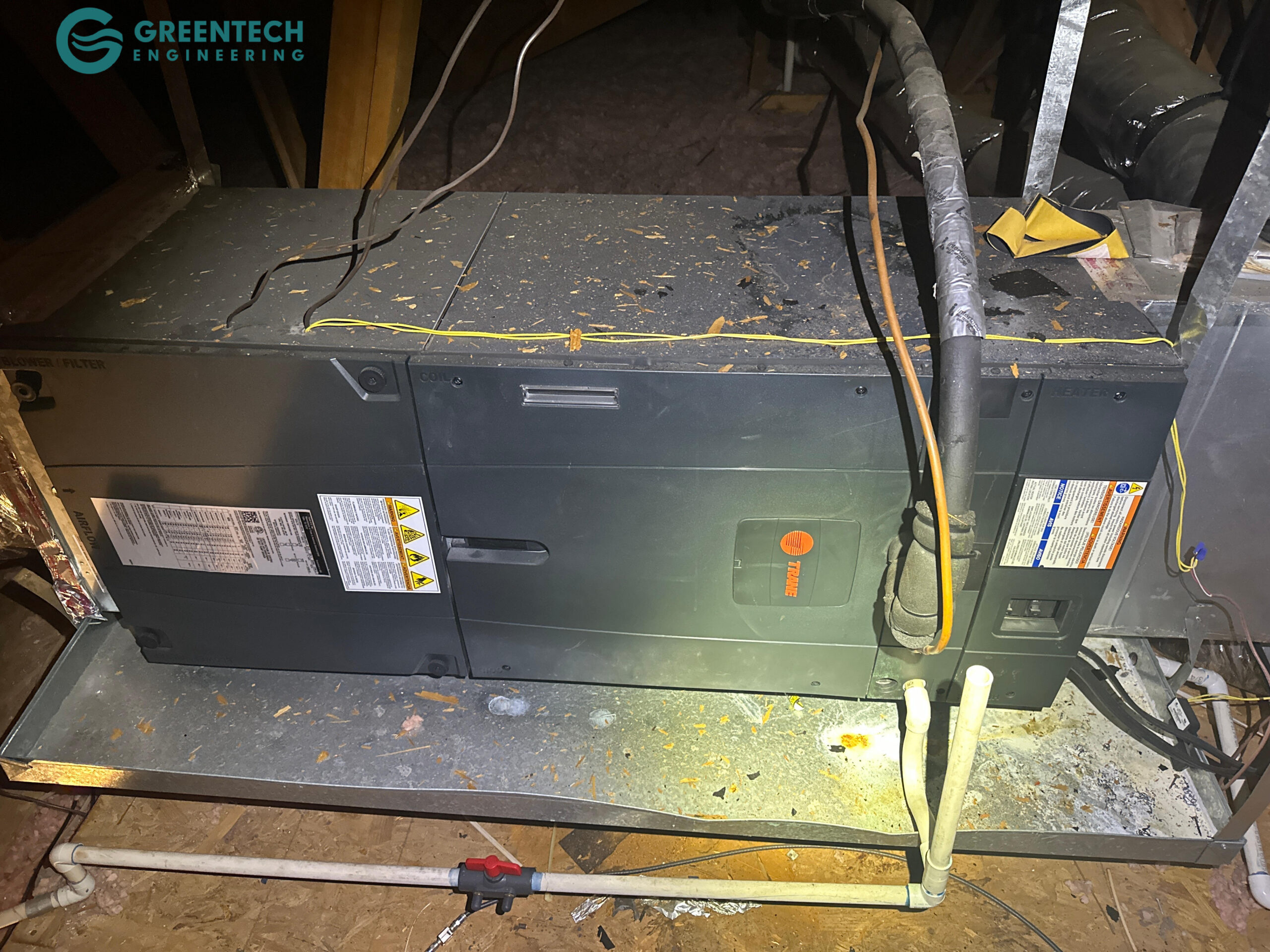 Old indoor HVAC air handler unit installed in a residential attic.