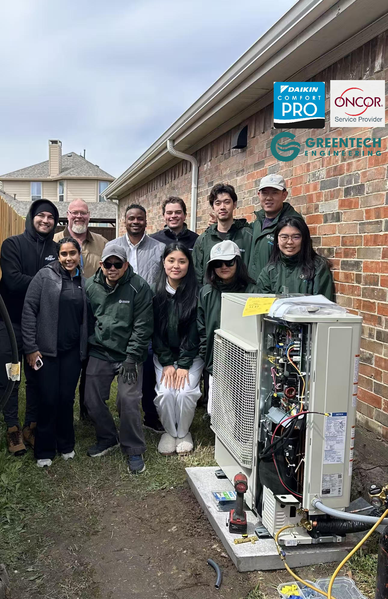 Greentech Engineering team and Daikin North America corporate team posing with a newly installed Daikin FIT side-discharge heat pump in Allen, TX.