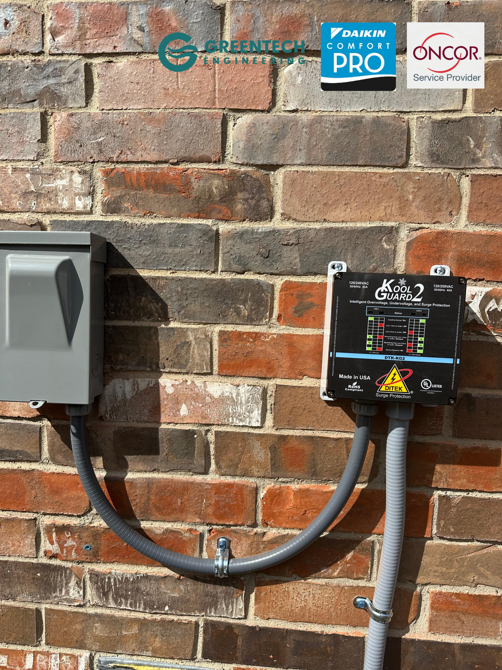 Close-up of a Kool Guard 220v voltage monitor and HVAC surge protector installed on a brick wall in Allen, TX.