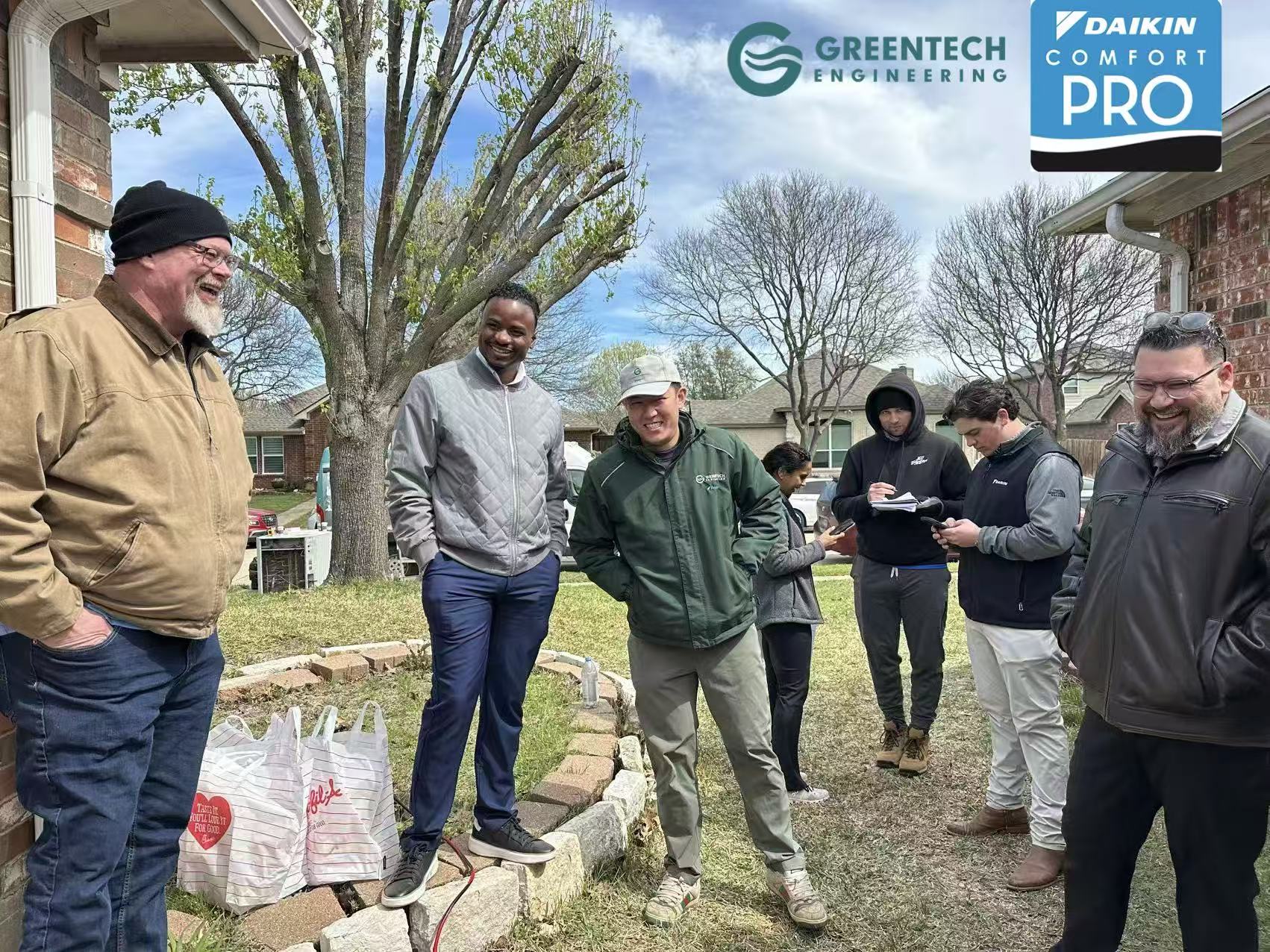 The Greentech Engineering team and Daikin North America corporate representatives sharing a laugh during a lunch break at a residential Daikin FIT installation site in Allen, Texas.