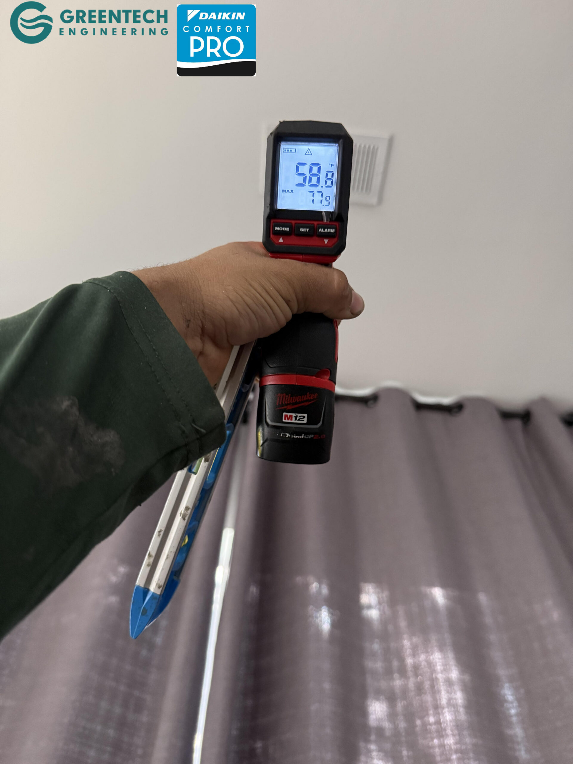 A digital infrared thermometer pointing at a residential ceiling vent in Dallas, registering a freezing 58.8 degrees Fahrenheit.