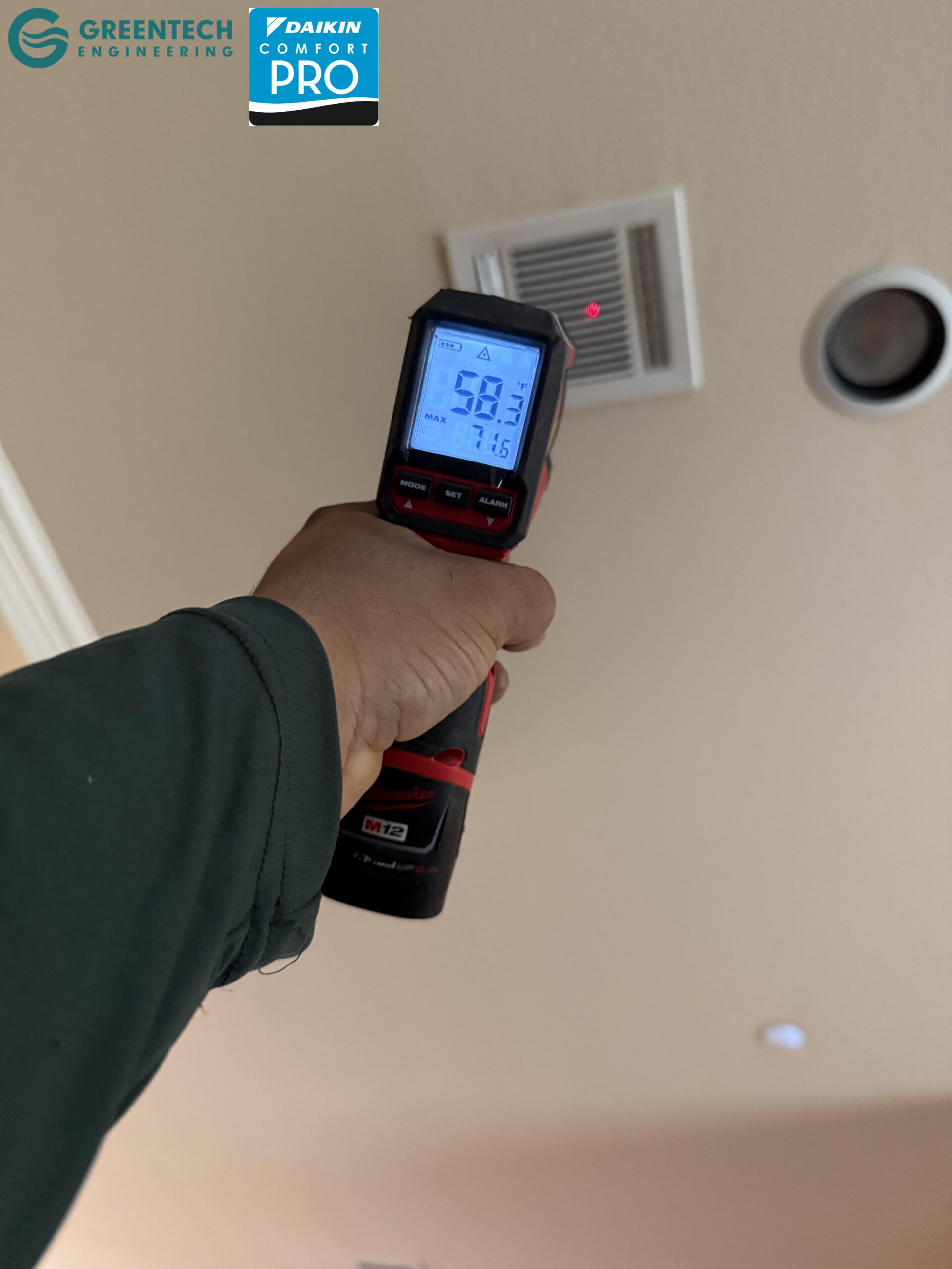  A digital infrared thermometer pointing at an indoor ceiling air vent in Dallas, TX, registering a frosty 58.3 degrees Fahrenheit.