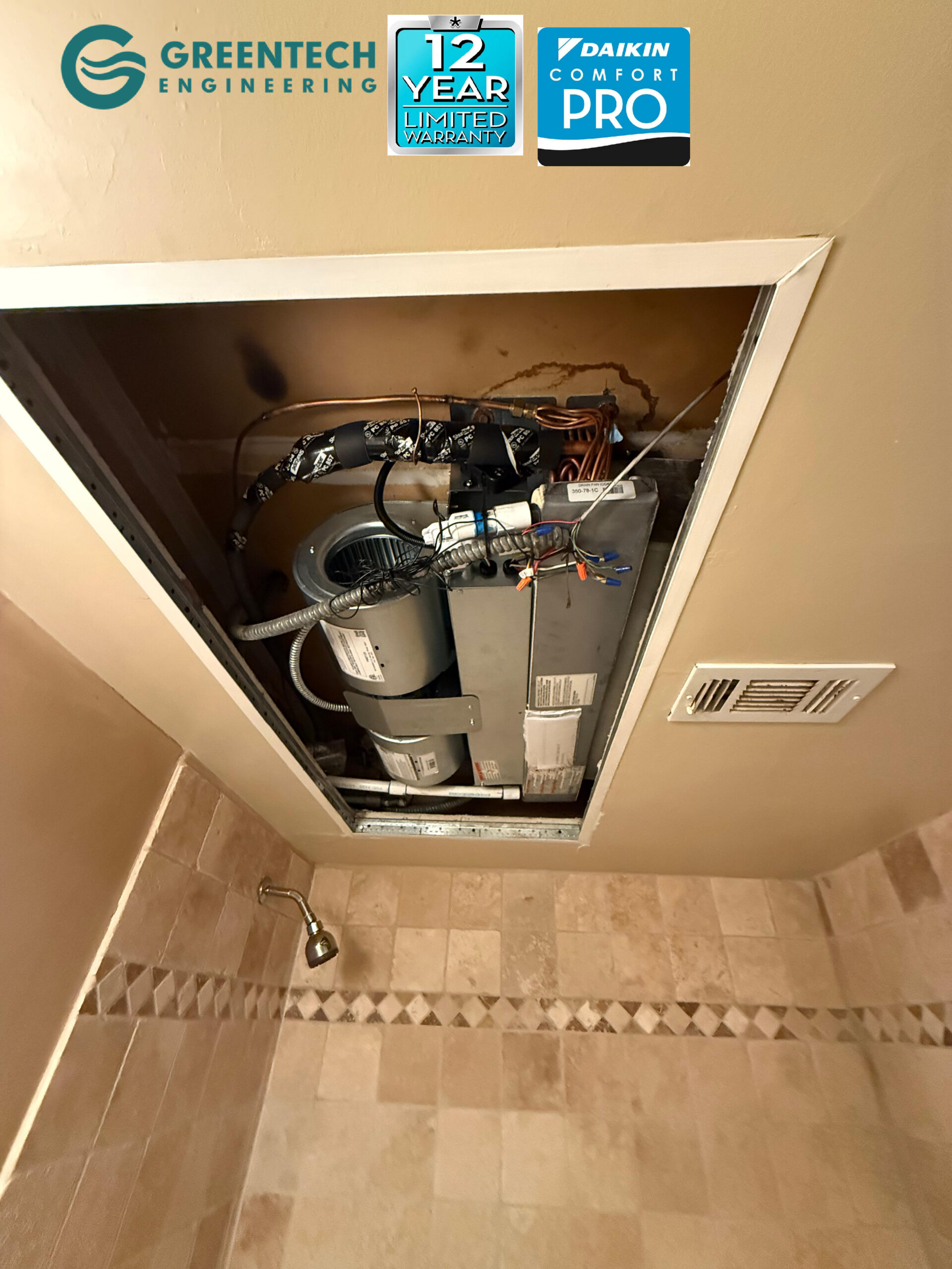 A brand new First Co ceiling mount air handler installed cleanly inside the drop ceiling above an apartment bathroom in Dallas.