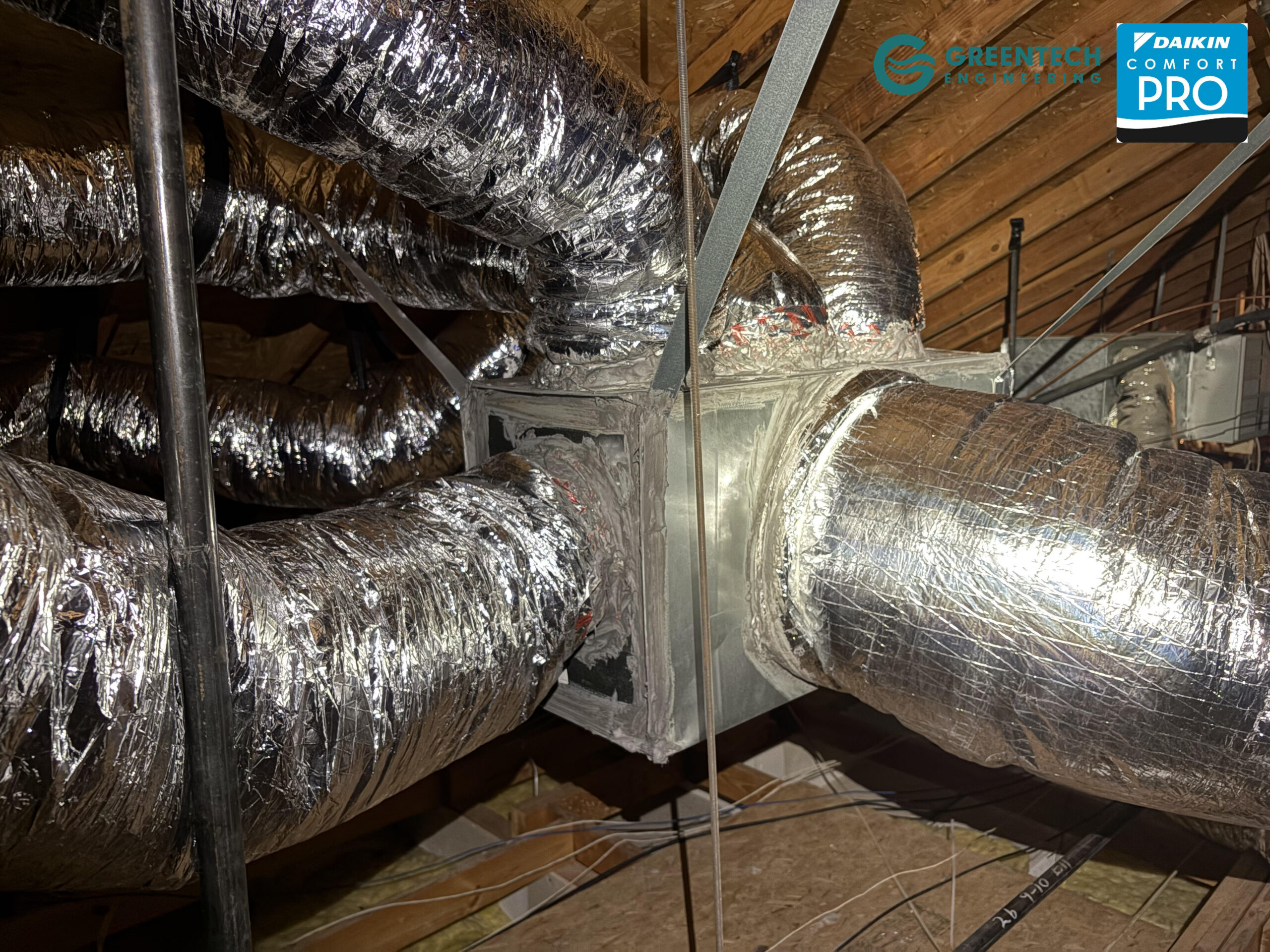 A custom-fabricated, heavy-duty insulated metal supply plenum securely connected to new commercial ductwork.