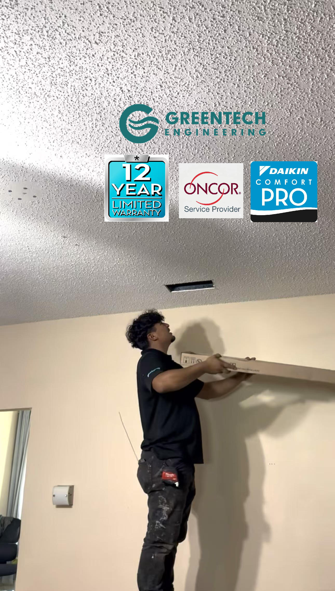 A Greentech HVAC technician installing a new rectangular supply air grille into the textured ceiling of a Dallas living room to balance the home's airflow.