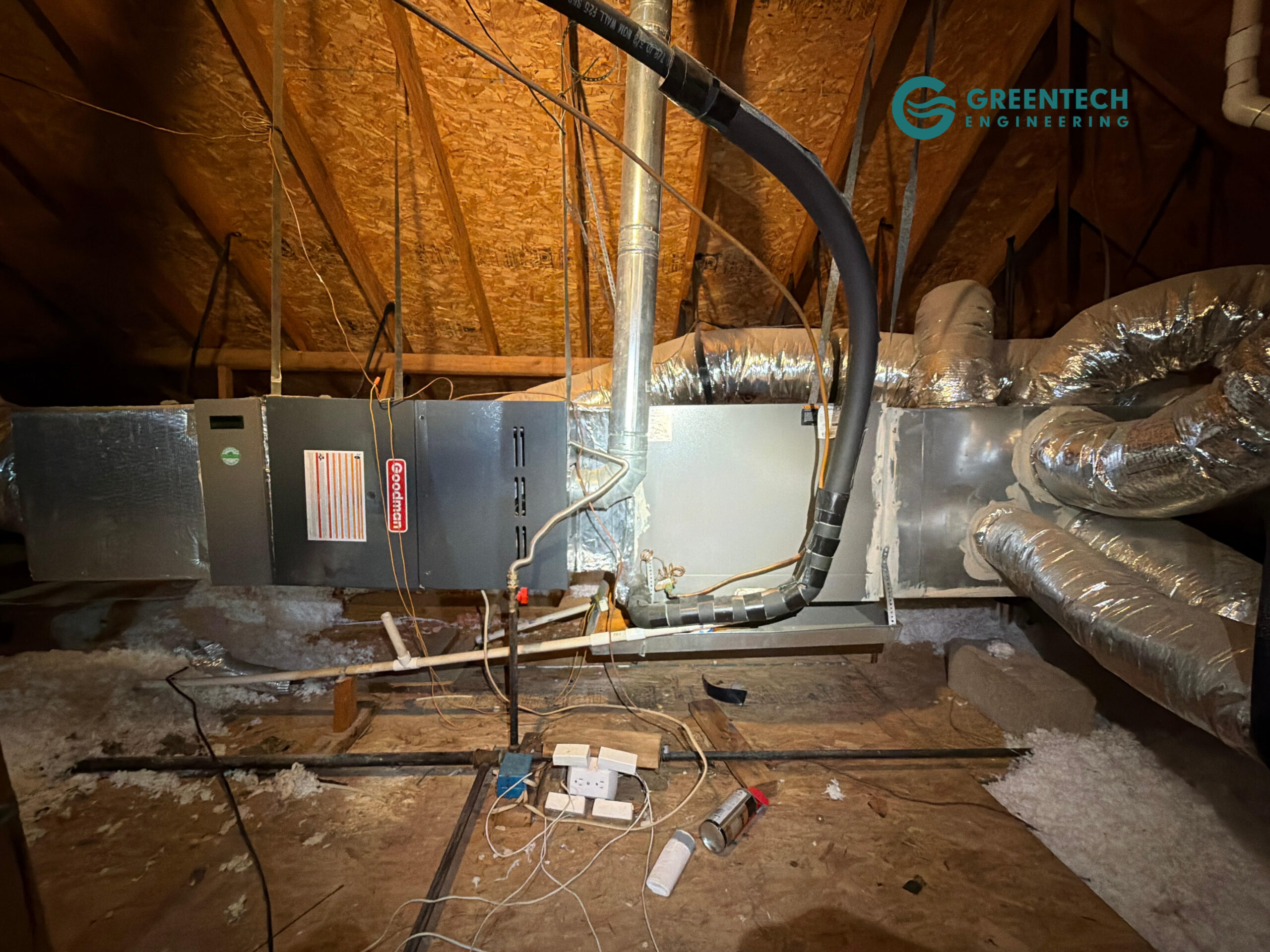 An older, inefficient horizontal gas furnace and evaporator coil suspended in a hot Dallas attic with tangled wiring and aging ductwork.