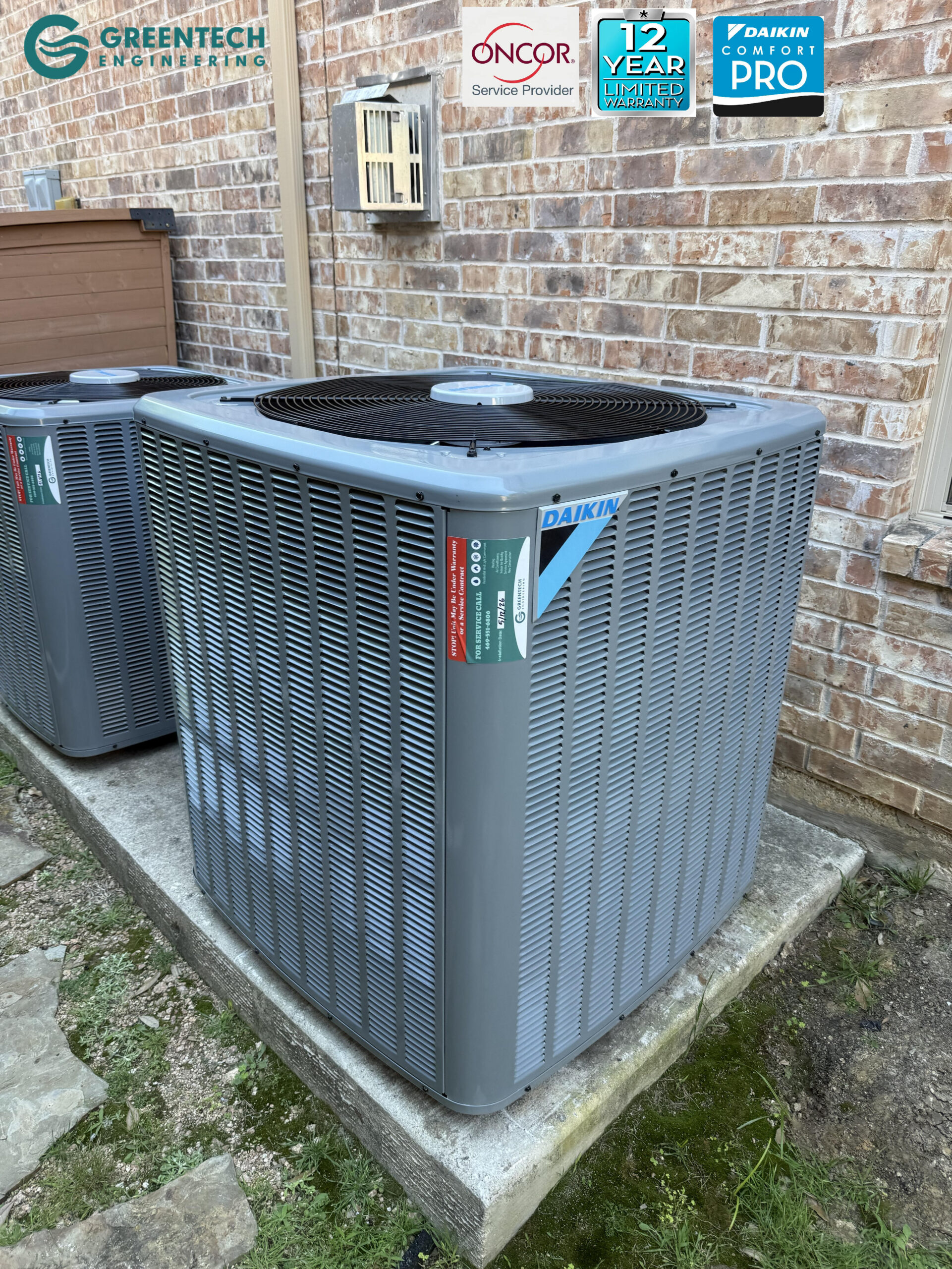 Two brand new, high-efficiency Daikin air conditioning condensers installed perfectly side-by-side on a level concrete pad in Dallas, Texas.