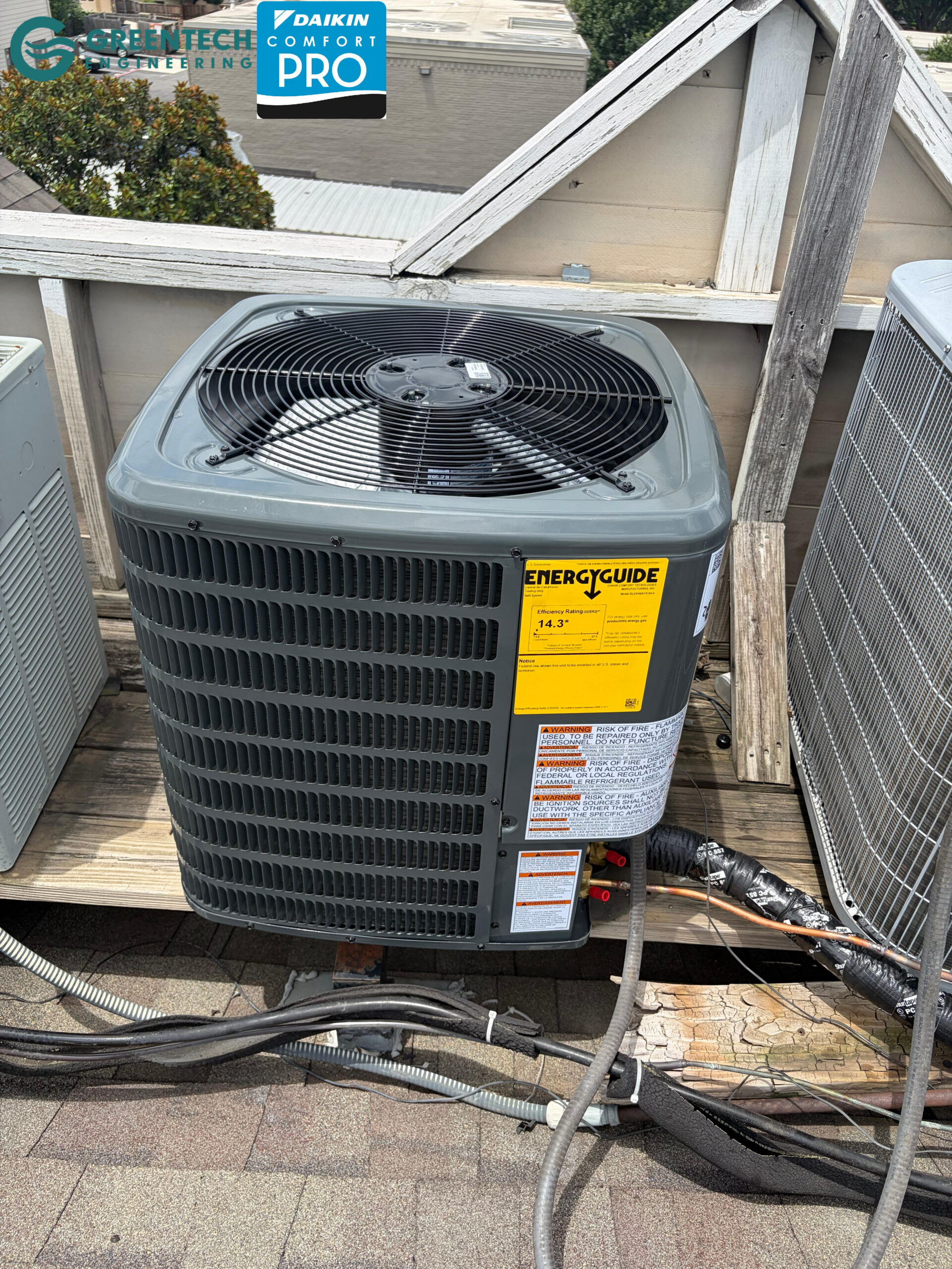 A pristine, energy-efficient Goodman 14.3 SEER2 air conditioning condenser installed on a secure rooftop platform in Forney, TX.