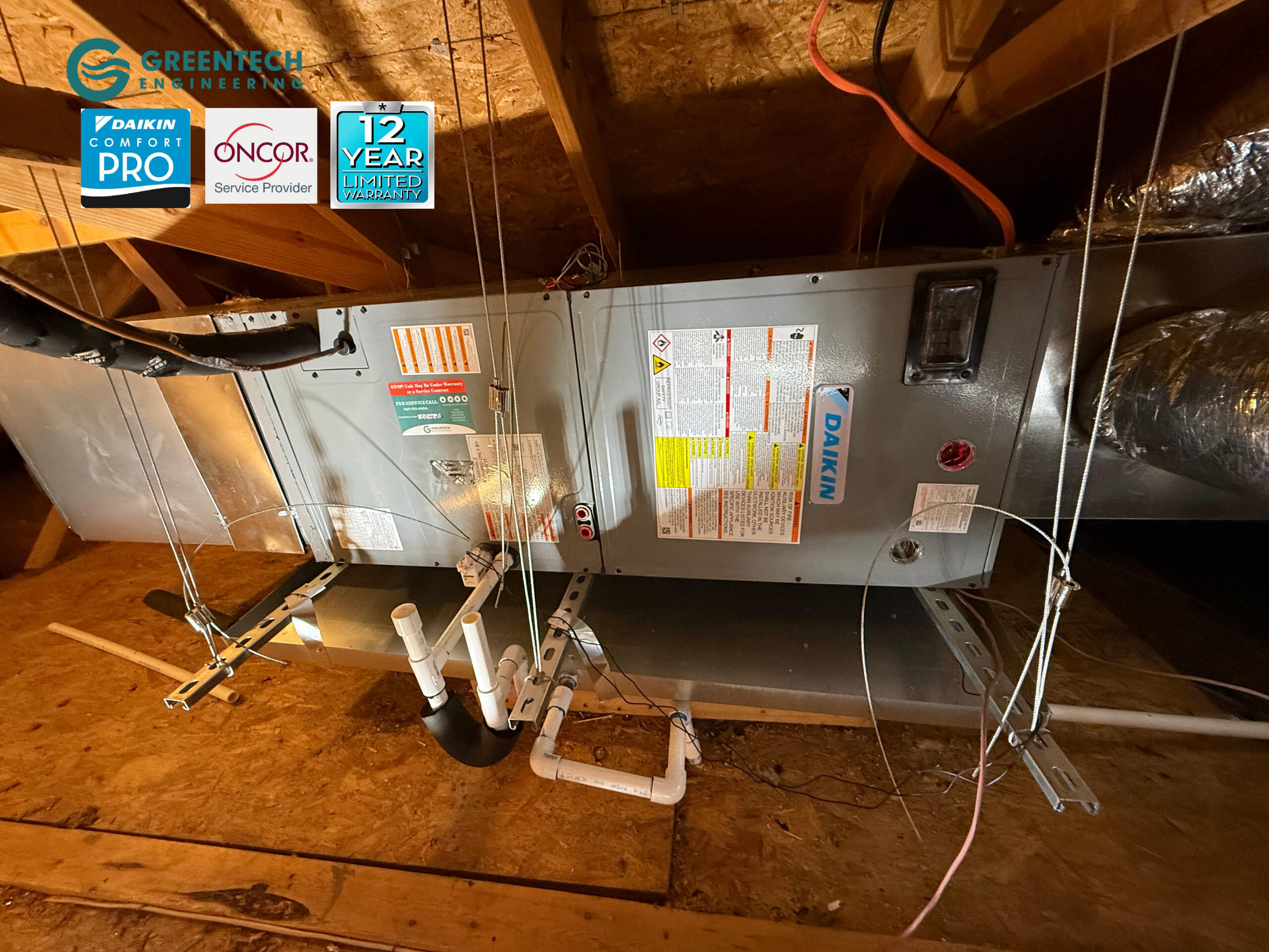 A horizontal Daikin multi-position air handler suspended cleanly in a residential attic with custom PVC drain lines and insulated ductwork.