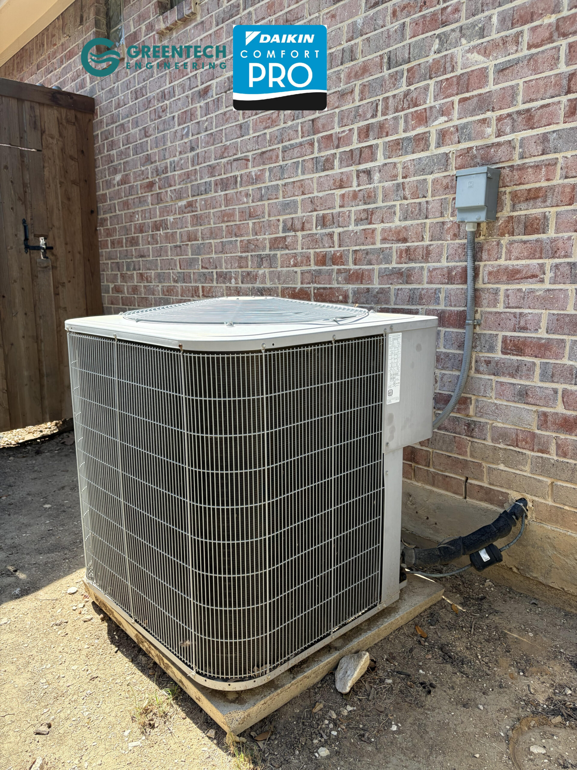 A Greentech Engineering technician identifying a failing, 17-year-old 3-Ton Carrier AC condenser in a Frisco, TX backyard before replacement.