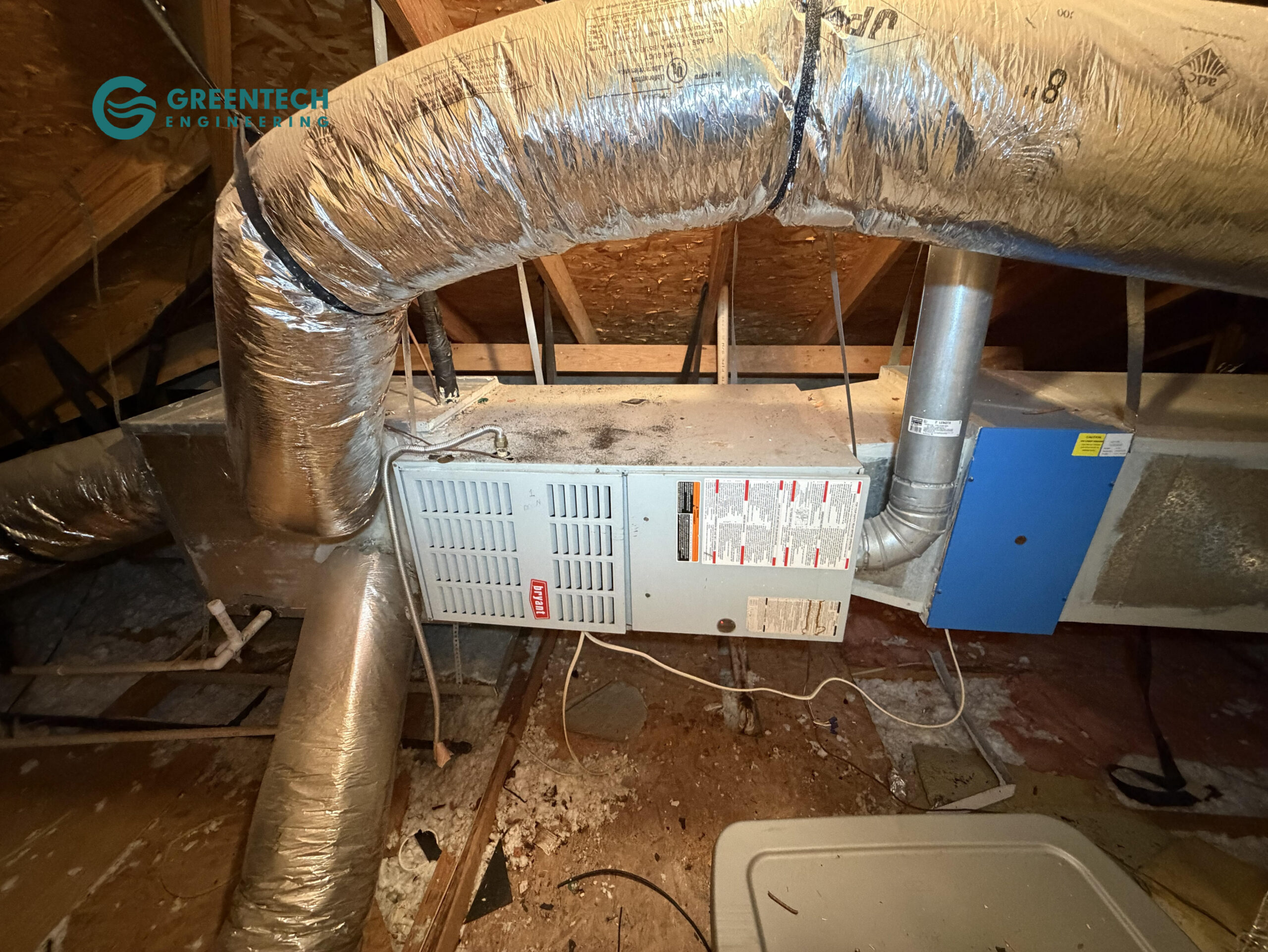 Old, failing Bryant indoor gas furnace and evaporator coil connected to restrictive, poorly designed ductwork in a Grand Prairie, TX attic before replacement.
