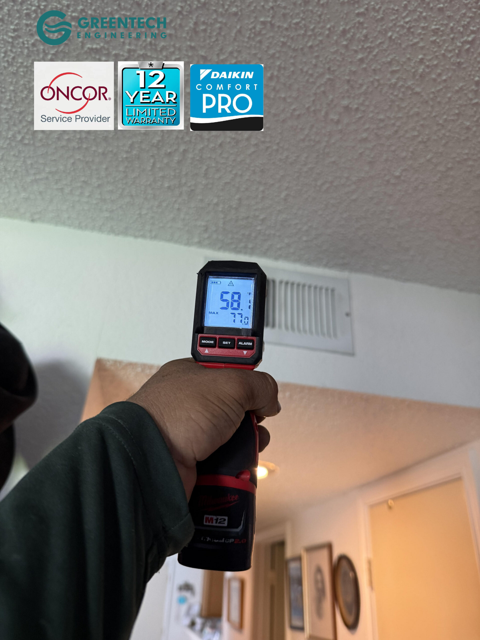 A digital infrared thermometer pointing at an indoor ceiling air vent in Grand Prairie, TX, registering a frosty 58.7 degrees Fahrenheit.