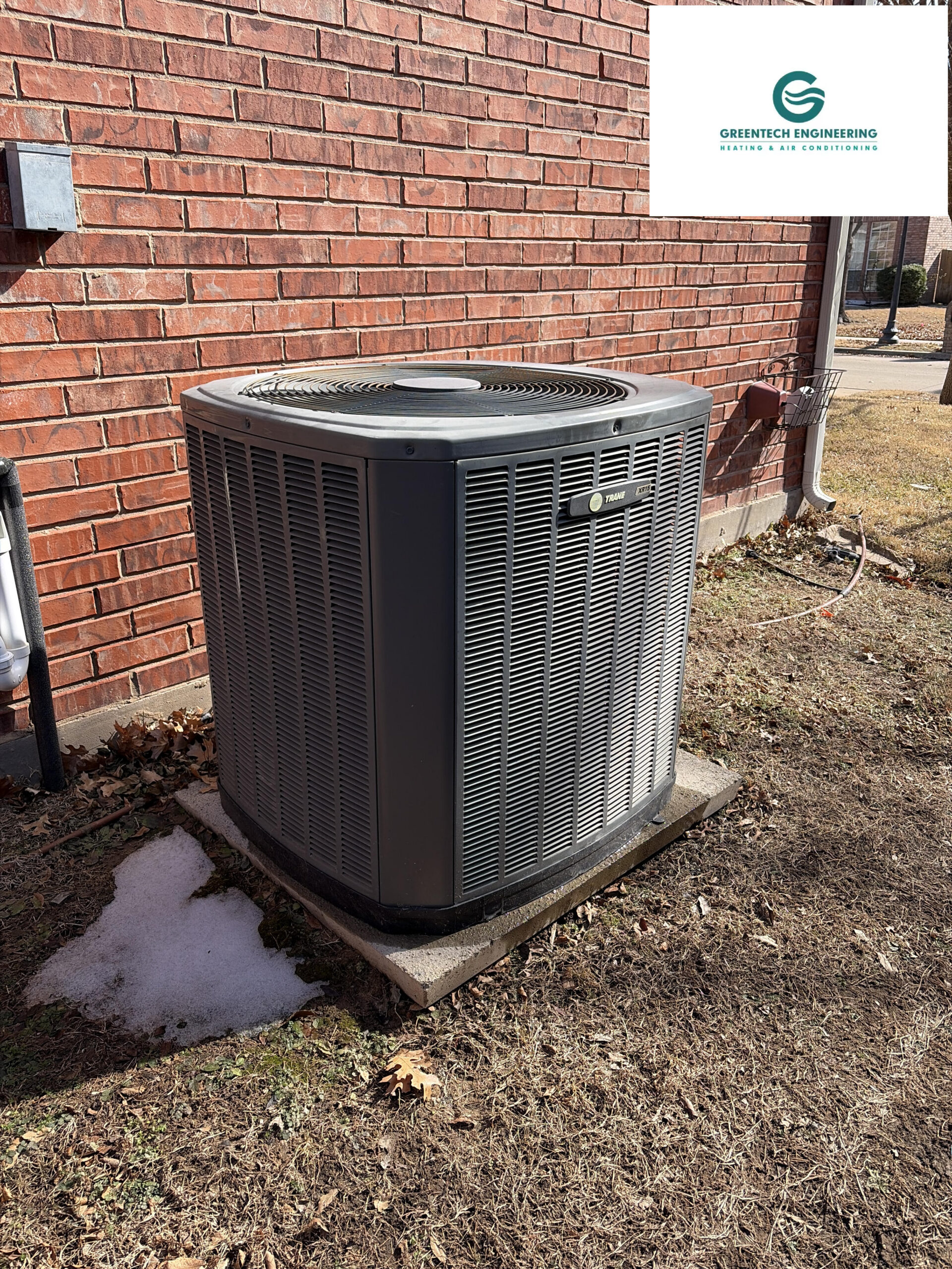 Old, inefficient 4-ton Trane outdoor AC condenser in a Grand Prairie, TX backyard prior to replacement