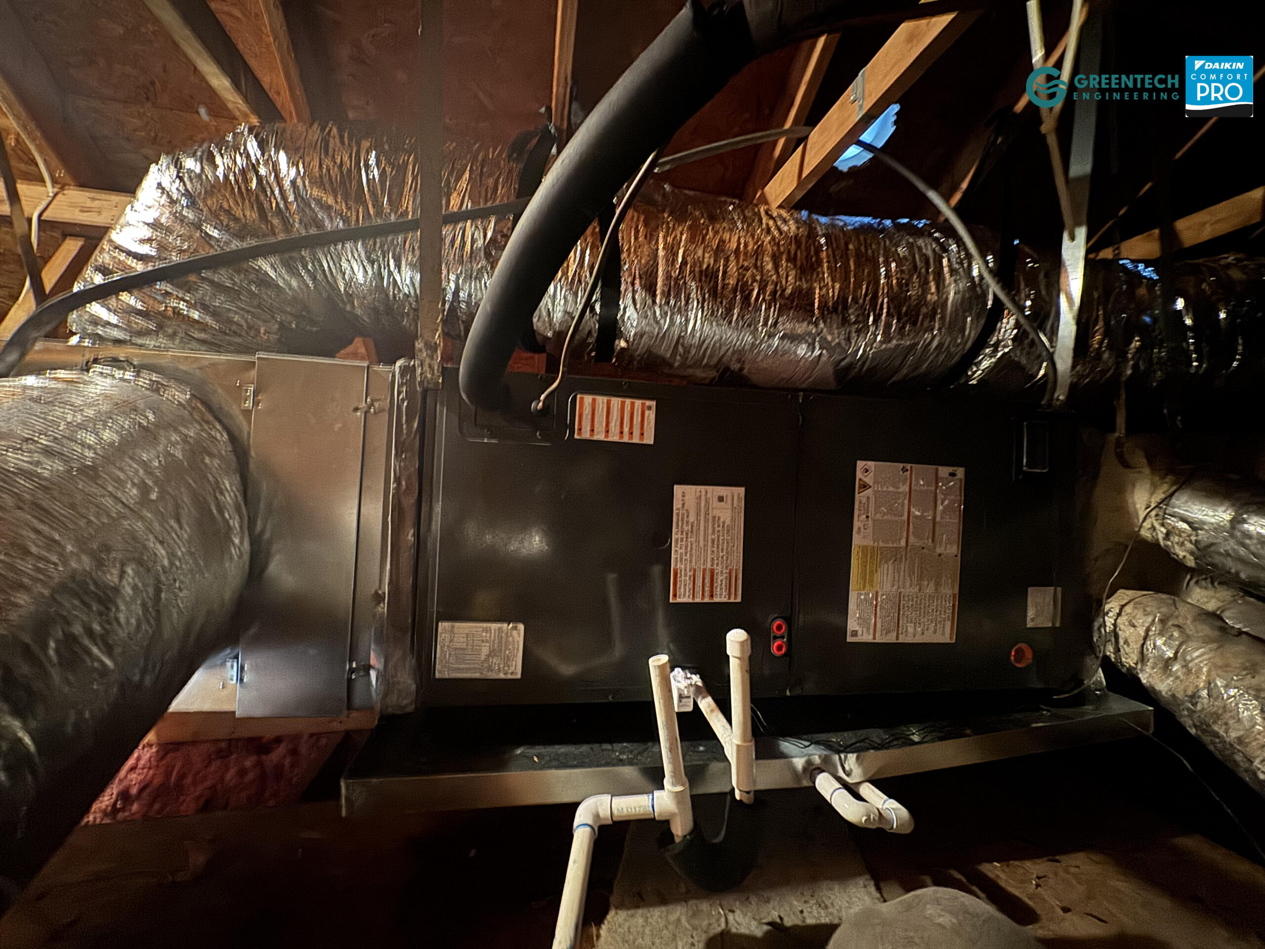 New Goodman 60k BTU Air Handler and flex duct installed neatly in a bright attic.