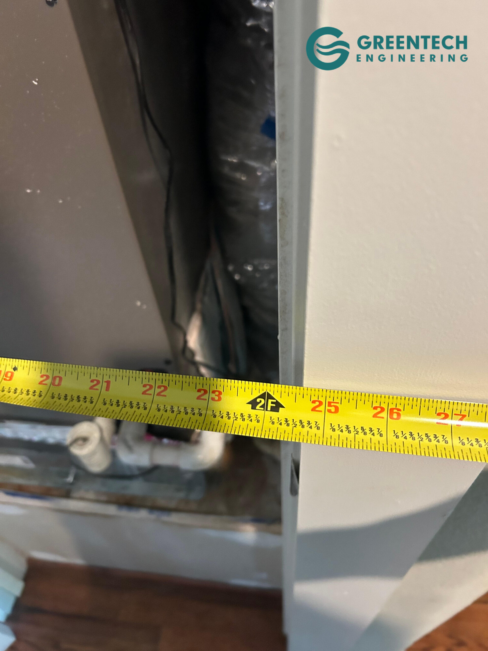 An HVAC engineer using a laser measurement tool to calculatedoor and window square footage and sun exposure for an ACCA Manual J calculation.