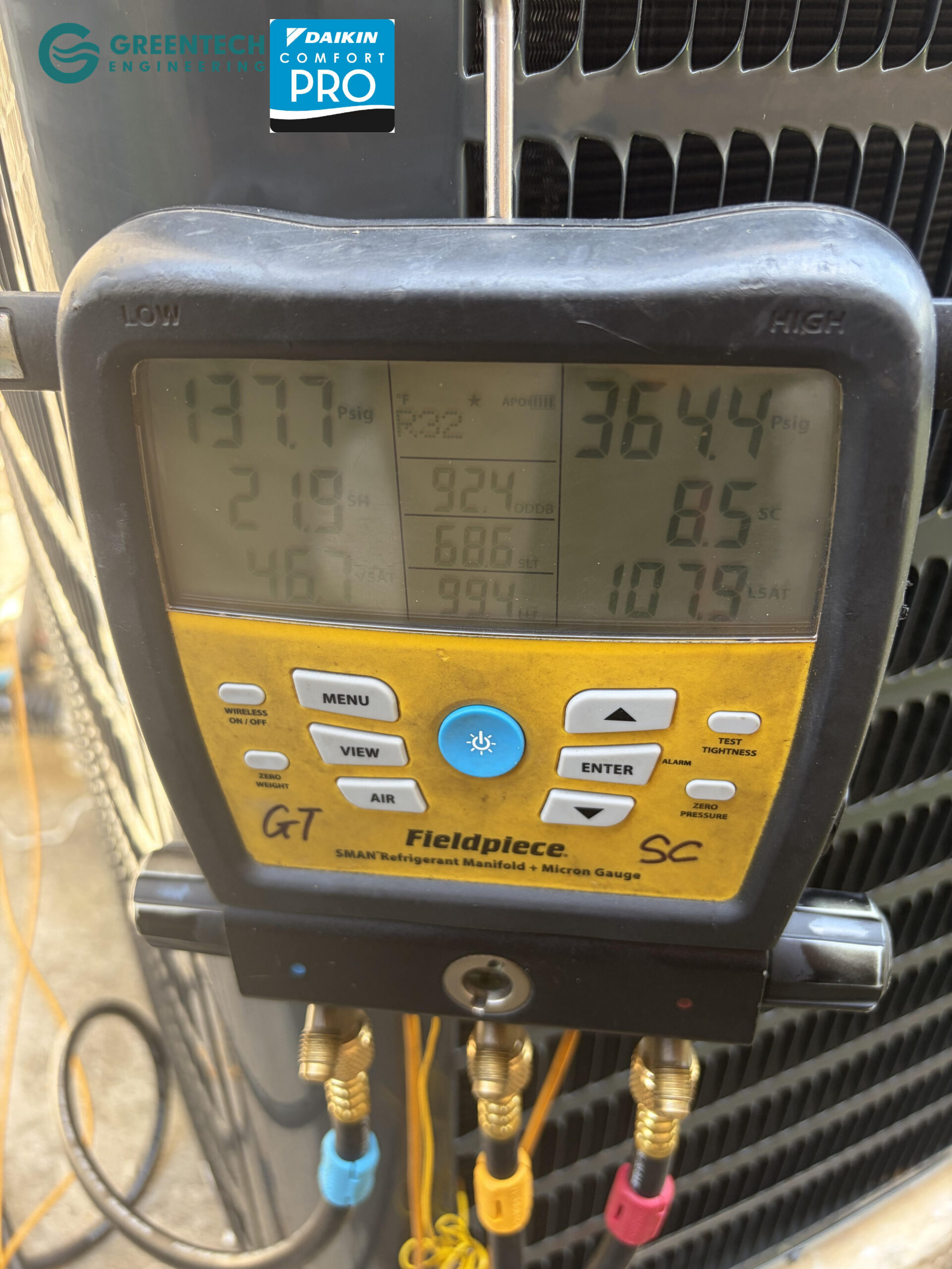  A specialized digital HVAC manifold gauge connected to a new Goodman condenser in Little Elm, TX, measuring exact refrigerant pressures and vacuum levels.