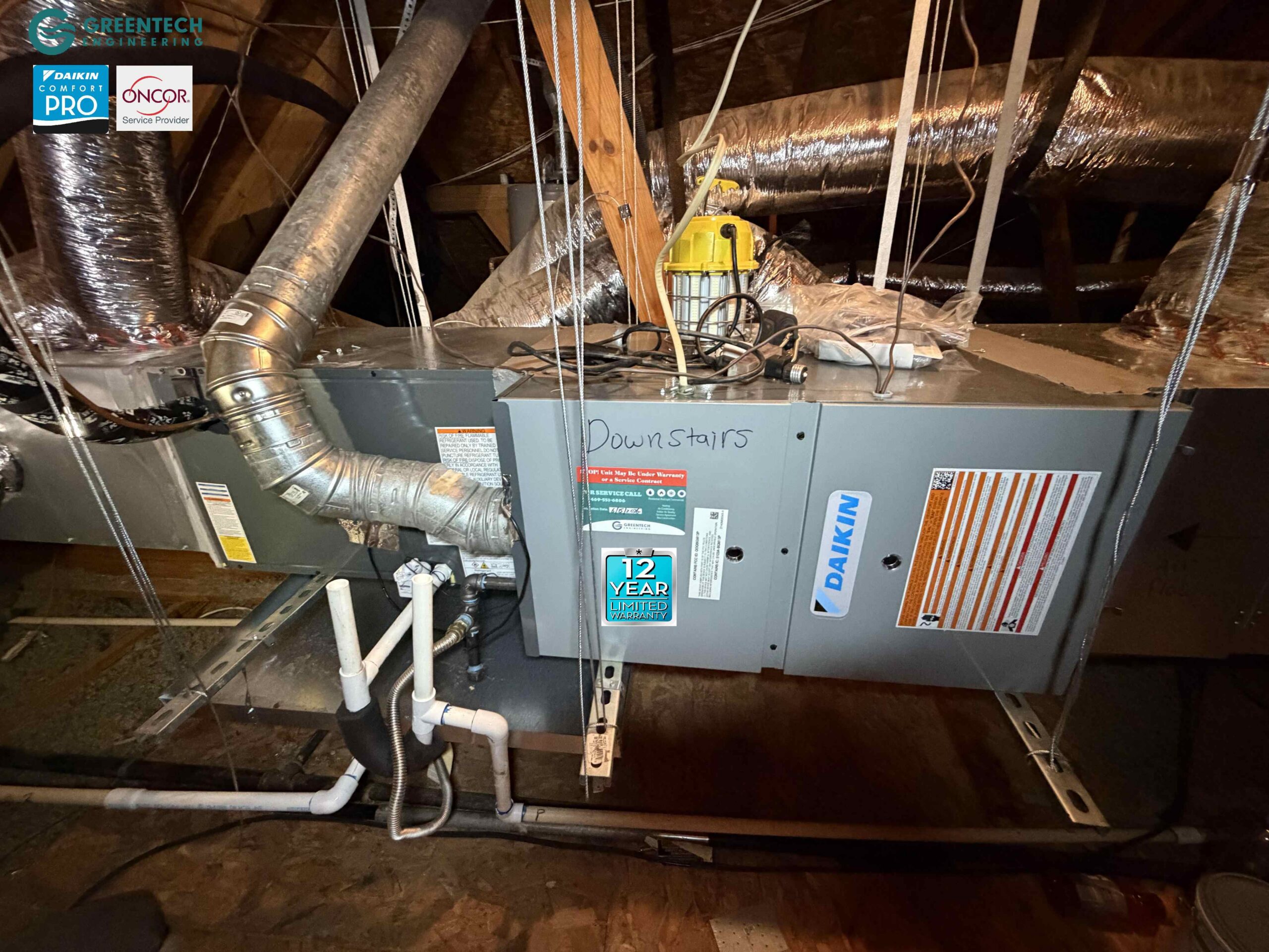 A pristine Daikin gas furnace and cased evaporator coil cleanly installed and suspended in a Plano attic, featuring new custom duct plenums.