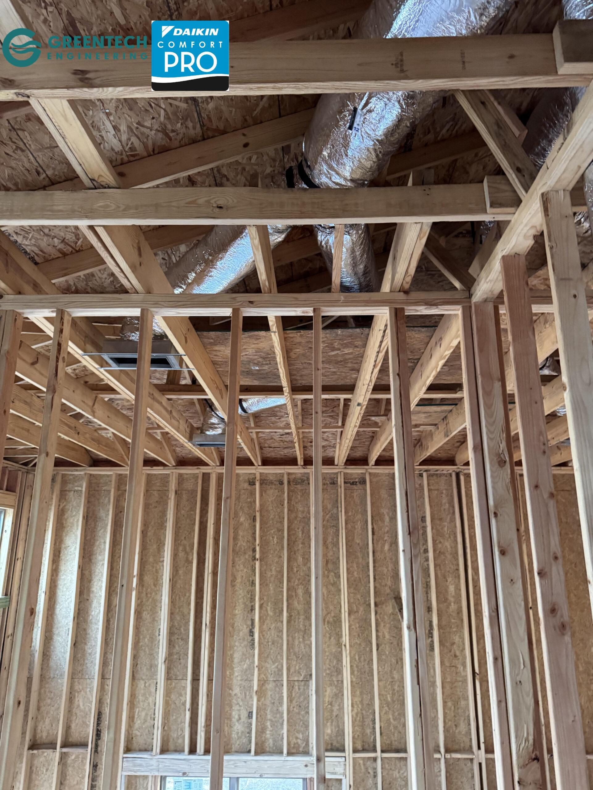 Complex R-8 insulated flexible HVAC ductwork routed precisely through the wooden roof trusses and framing of a new home in Plano, TX.