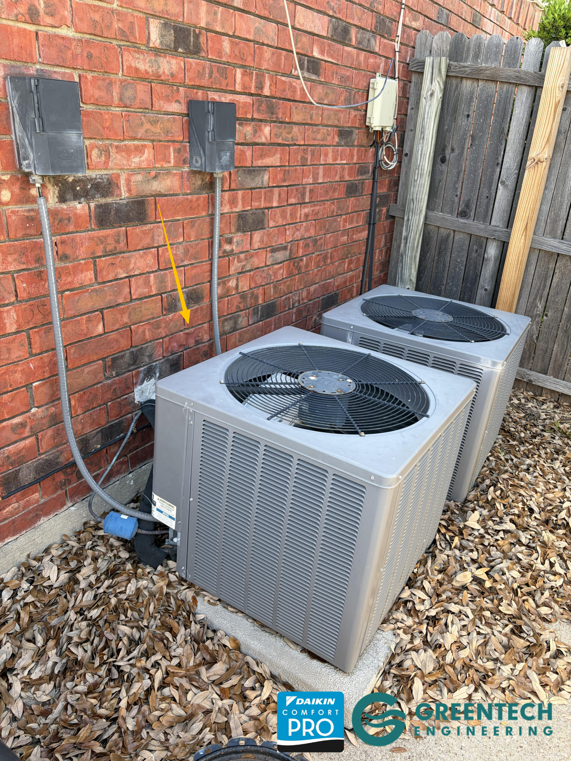 An aging, single-stage 3-Ton Rheem AC condenser sitting on a weathered pad in the side yard of a Plano, Texas home before being replaced.