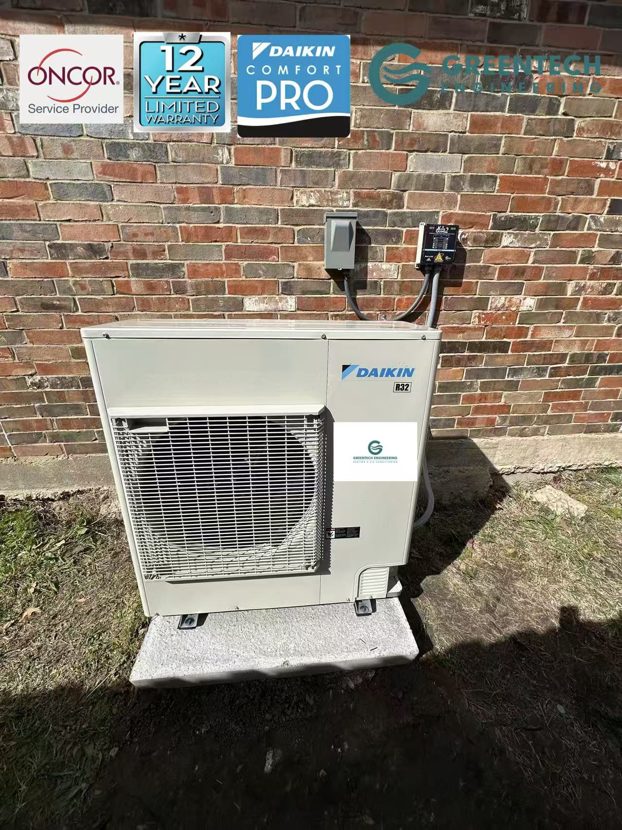 A fully installed Daikin Fit side-discharge variable-speed heat pump sitting on a concrete pad against a brick wall, featuring an electrical disconnect box and a dedicated surge protector.